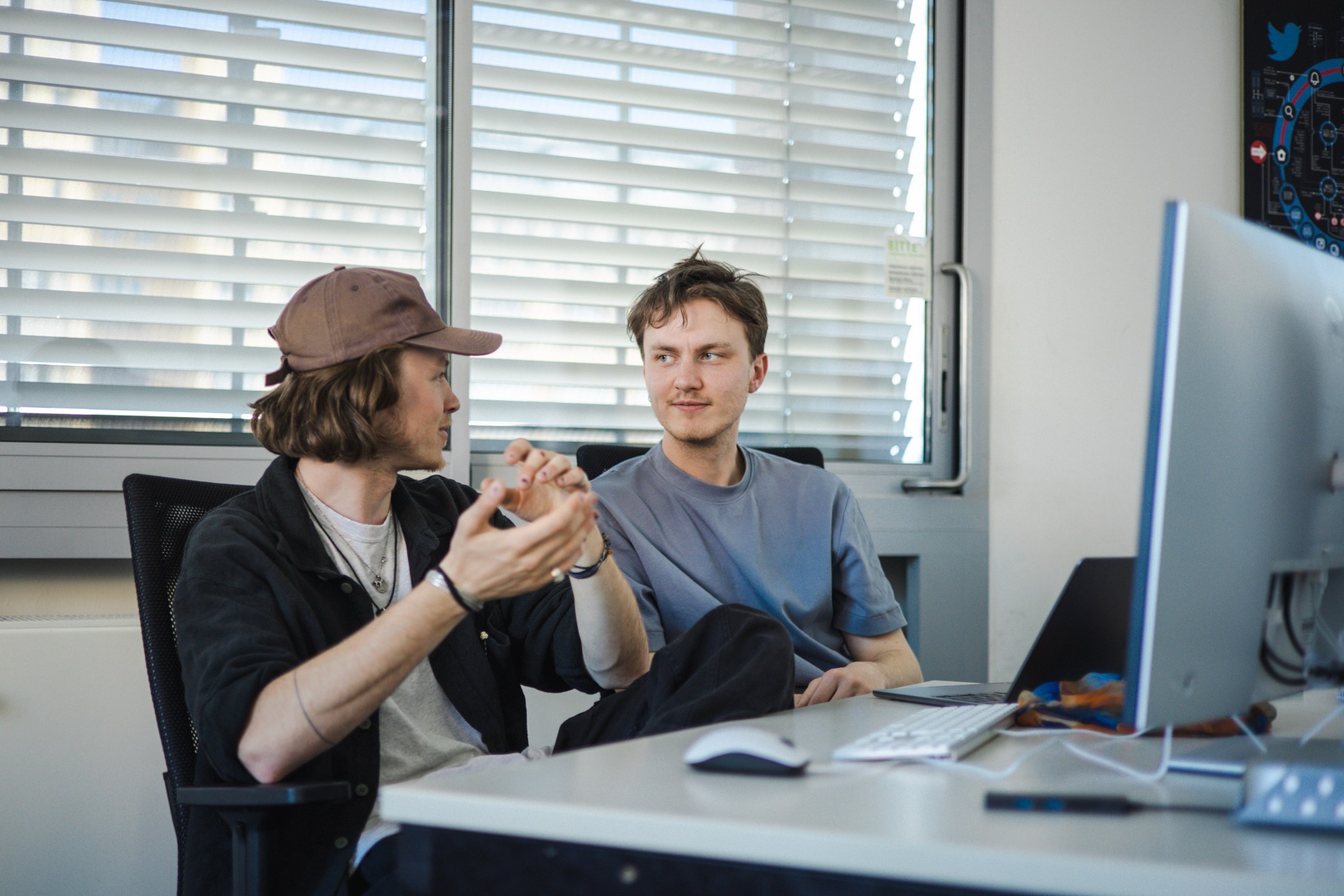 Team members in an office setting having a discussion, representing clear communication throughout the project process.