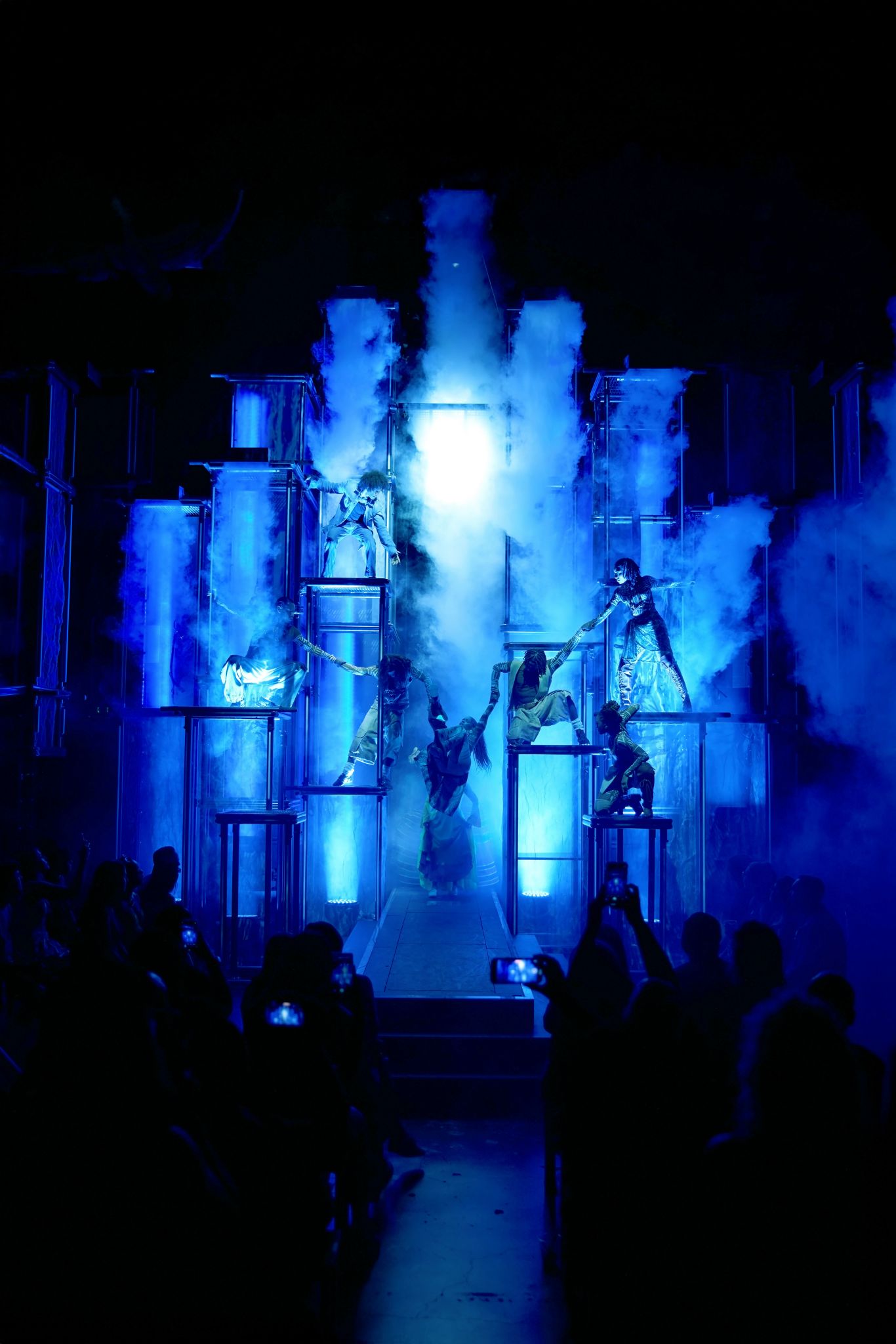 Full cast performance on towering set representing Bob's struggles against society