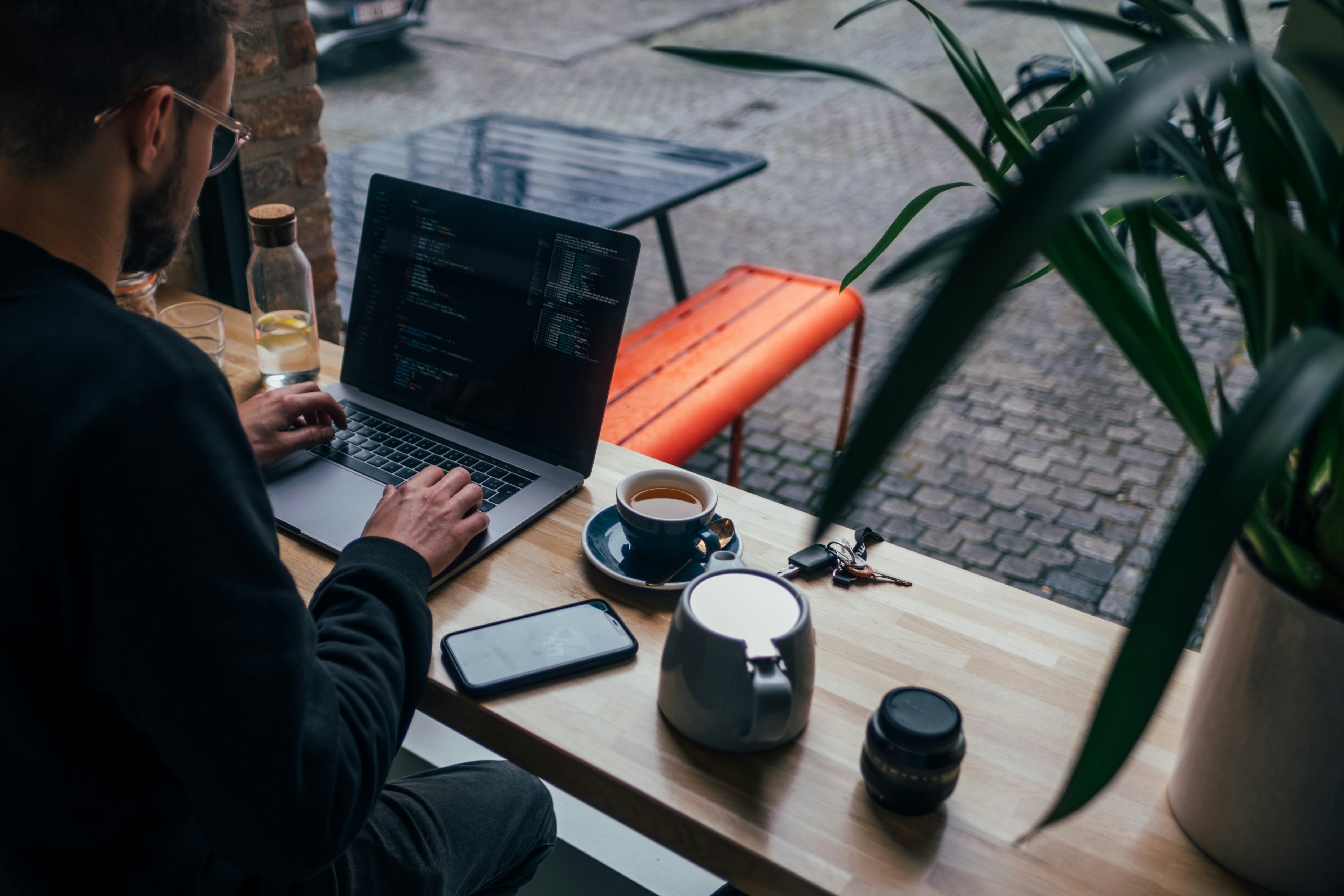 person sitting in cafe using Best AI Writing Assistant