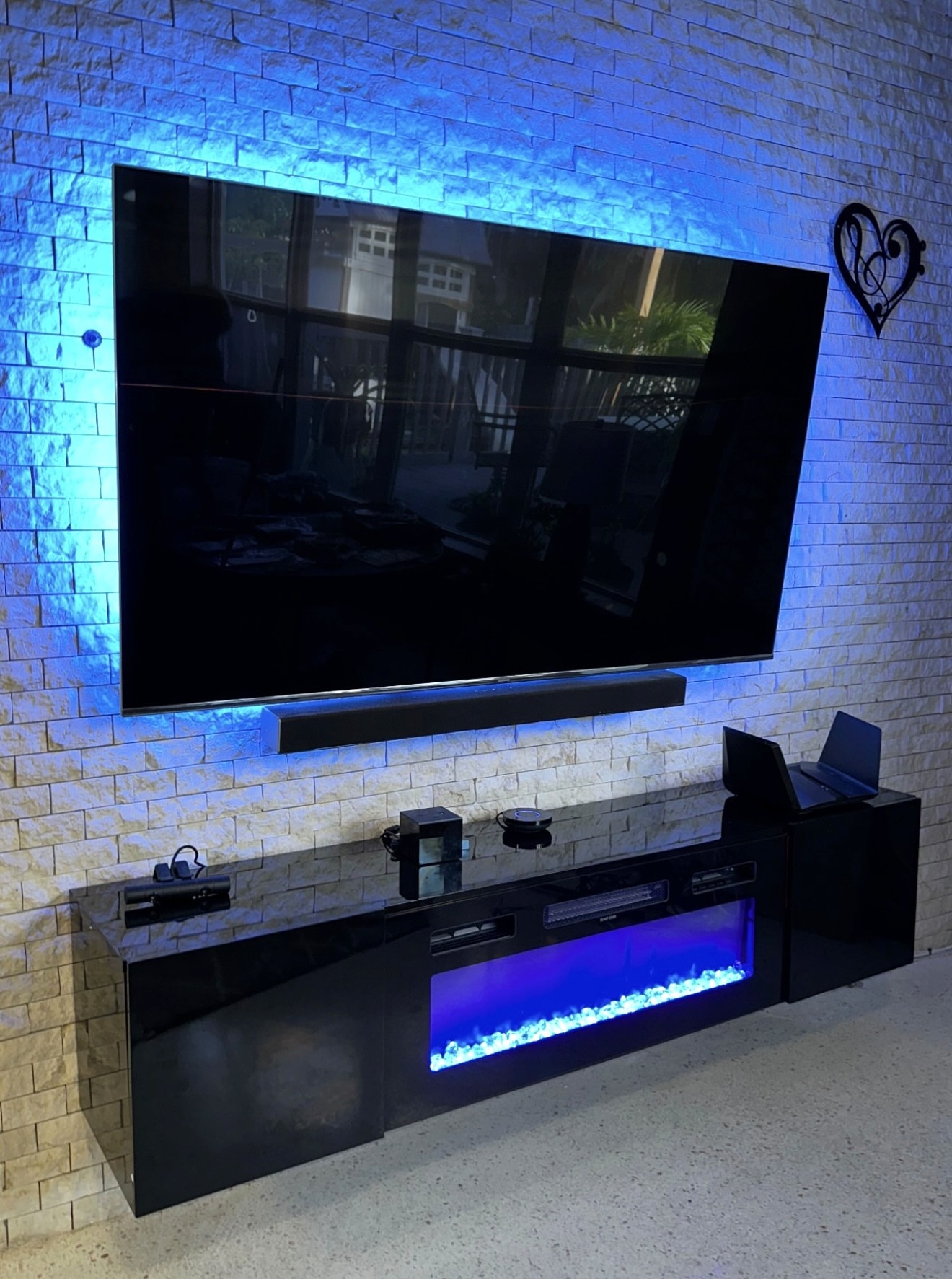 75 inch TV Mounted with Soundbar and light blue LED Lights