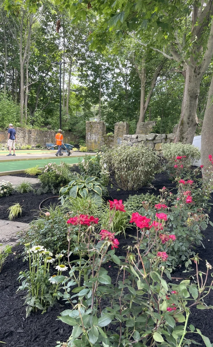 Price Landscape and Construction finished project of an outdoor bocce ball court and floral garden