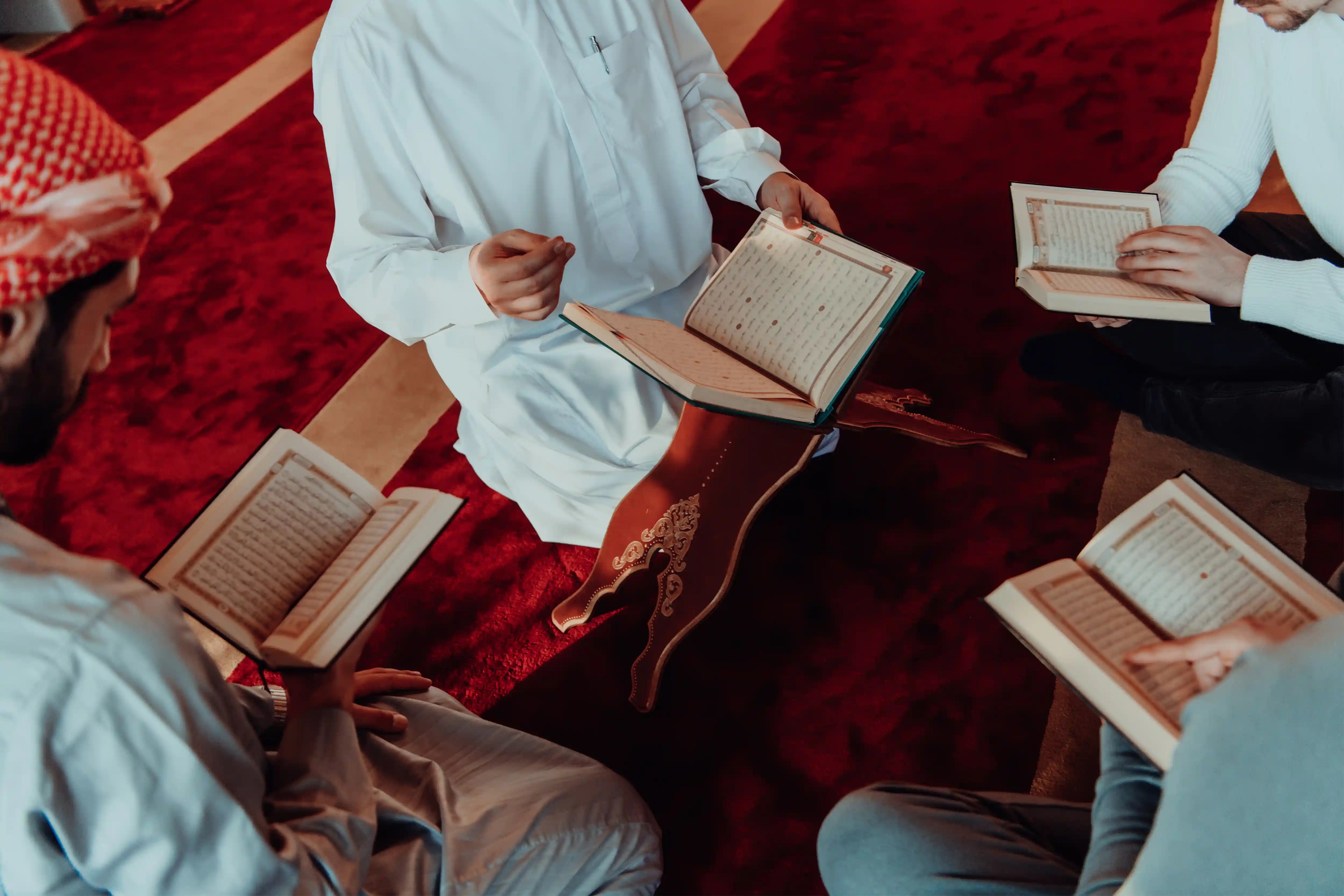 group of women in red and white dress standing on brown wooden bar during daytime