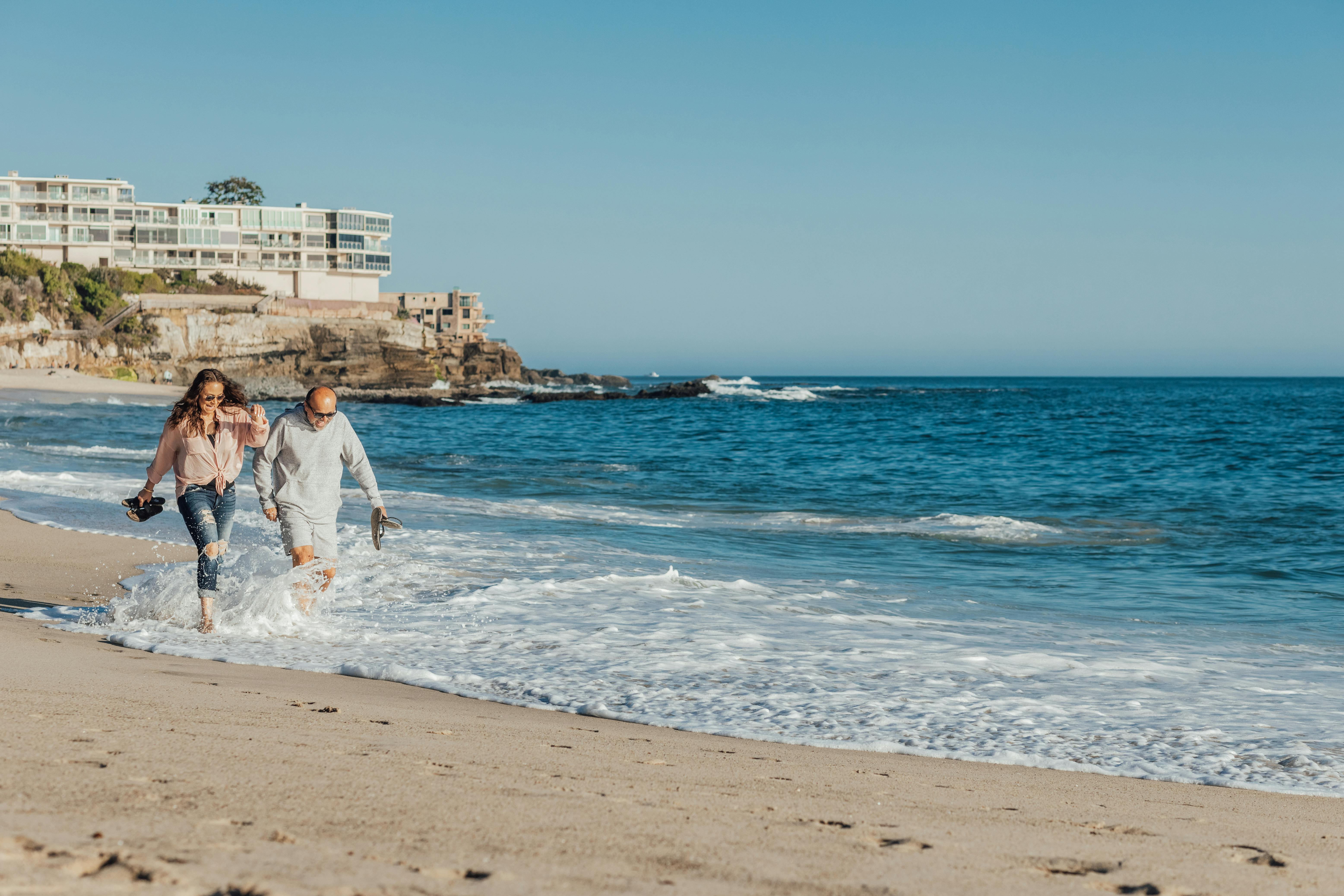 Middle aged couple walking on a beach