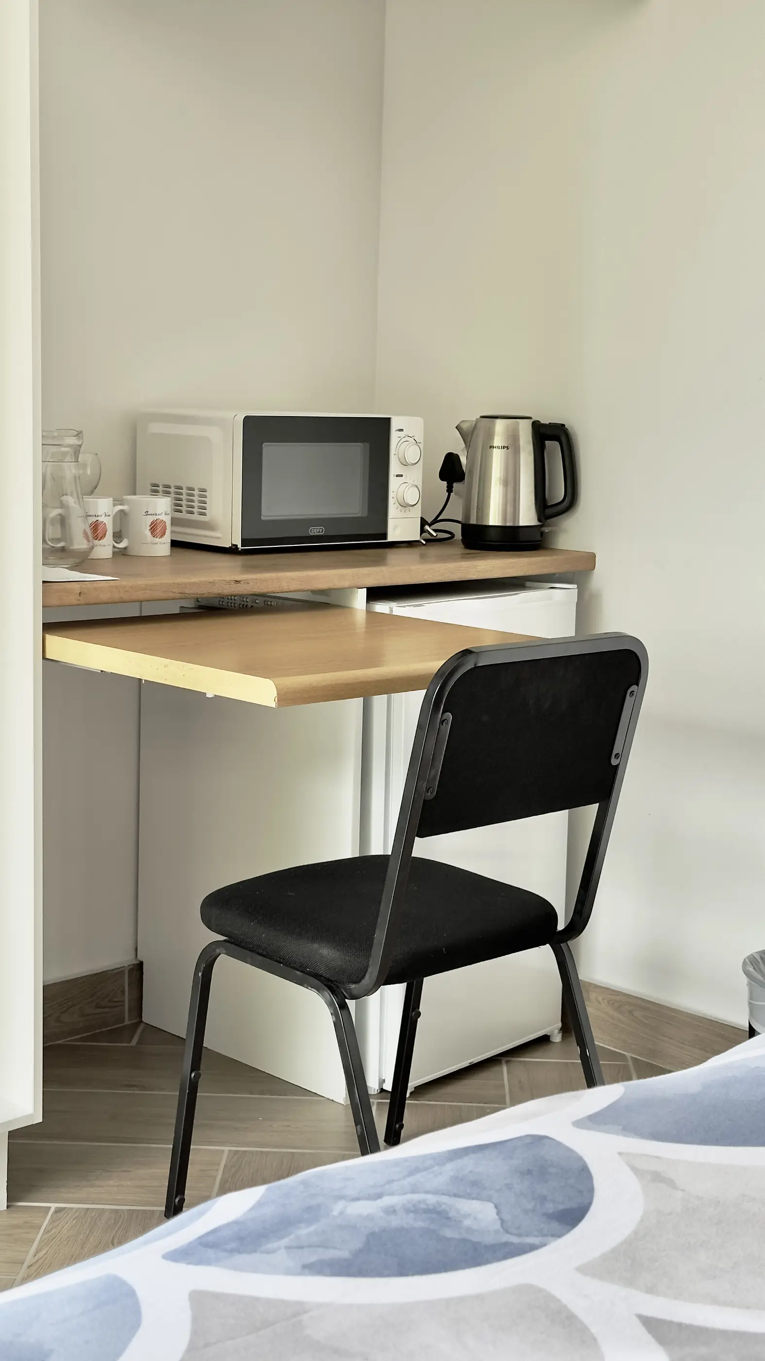 The honesty bar fridge and workspace desk in our A View Twenty-Four 7 room.