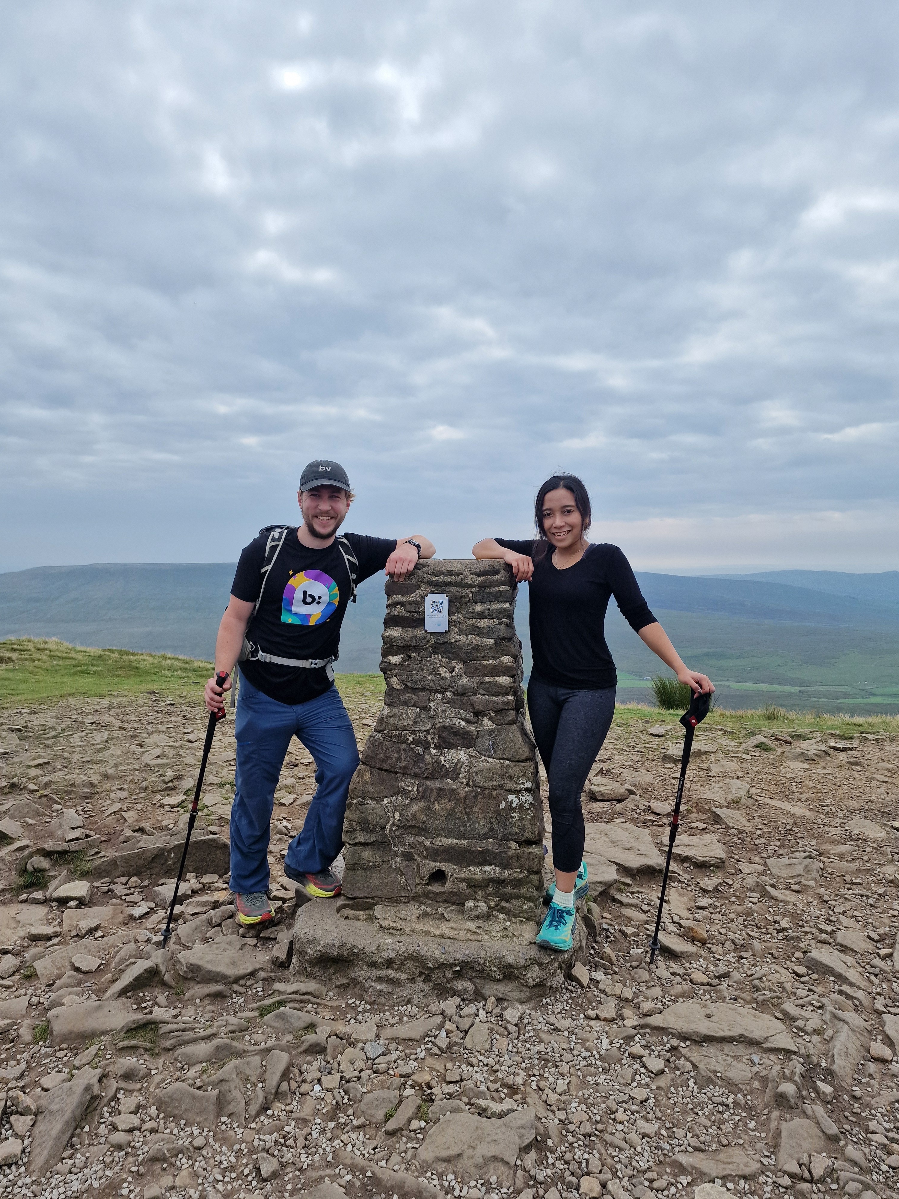 A close-up of two people holding hands, one wearing a denim jacket. The background is softly blurred, suggesting a tender, intimate moment in warm light.