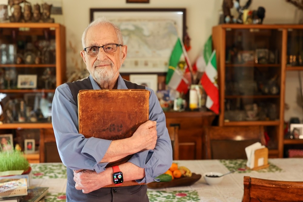 Bubjan with book and speaking to camera