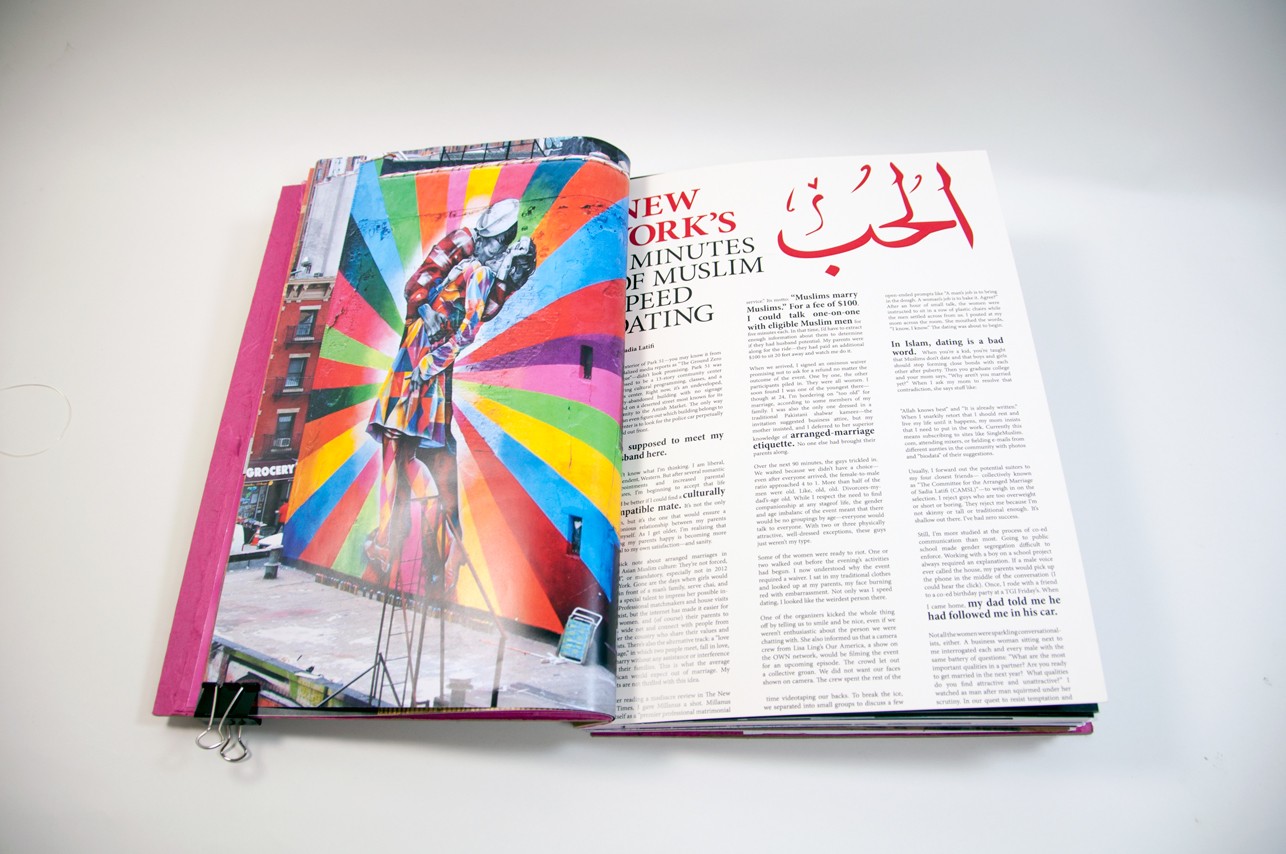 an opened book depicting a picture of a stage with a colorful backdrop on the left side and a lot of text on the right side