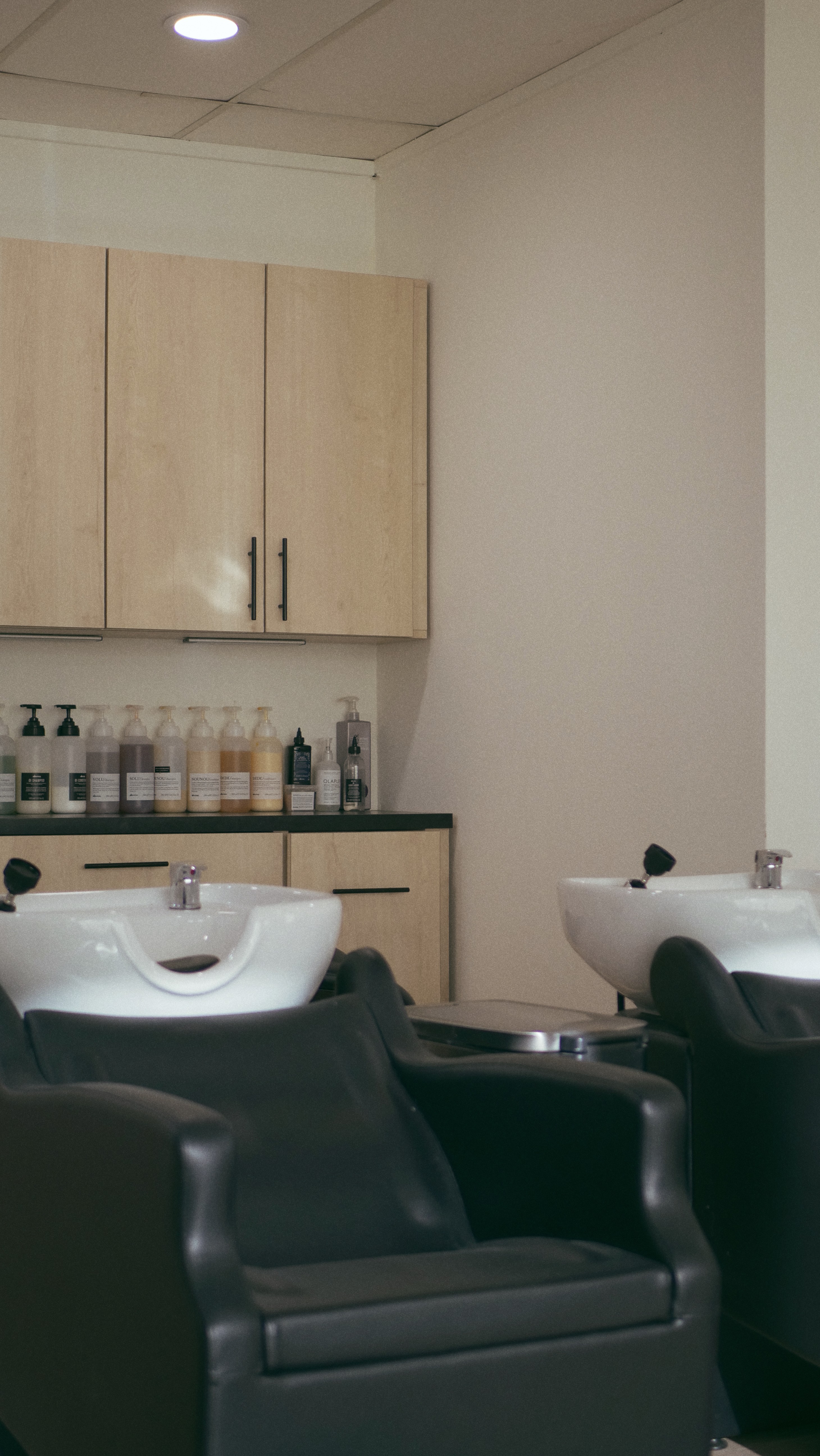 A close-up of a serene face illuminated by soft light, with shadows creating a patterned effect across the skin.