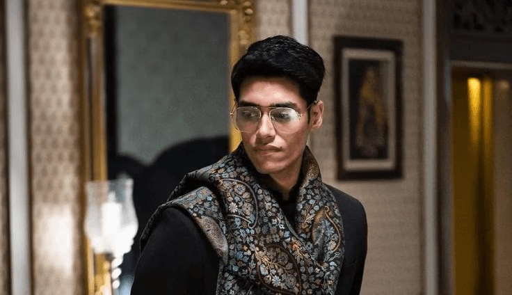 woman in blue bralette holding sunglasses putting on her eyes