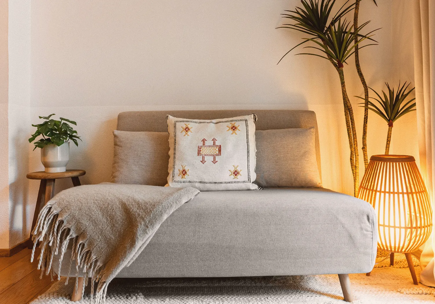 Garden N°1 • grey daybed sofa with a Berber cushion, a woven floor lamp and plants