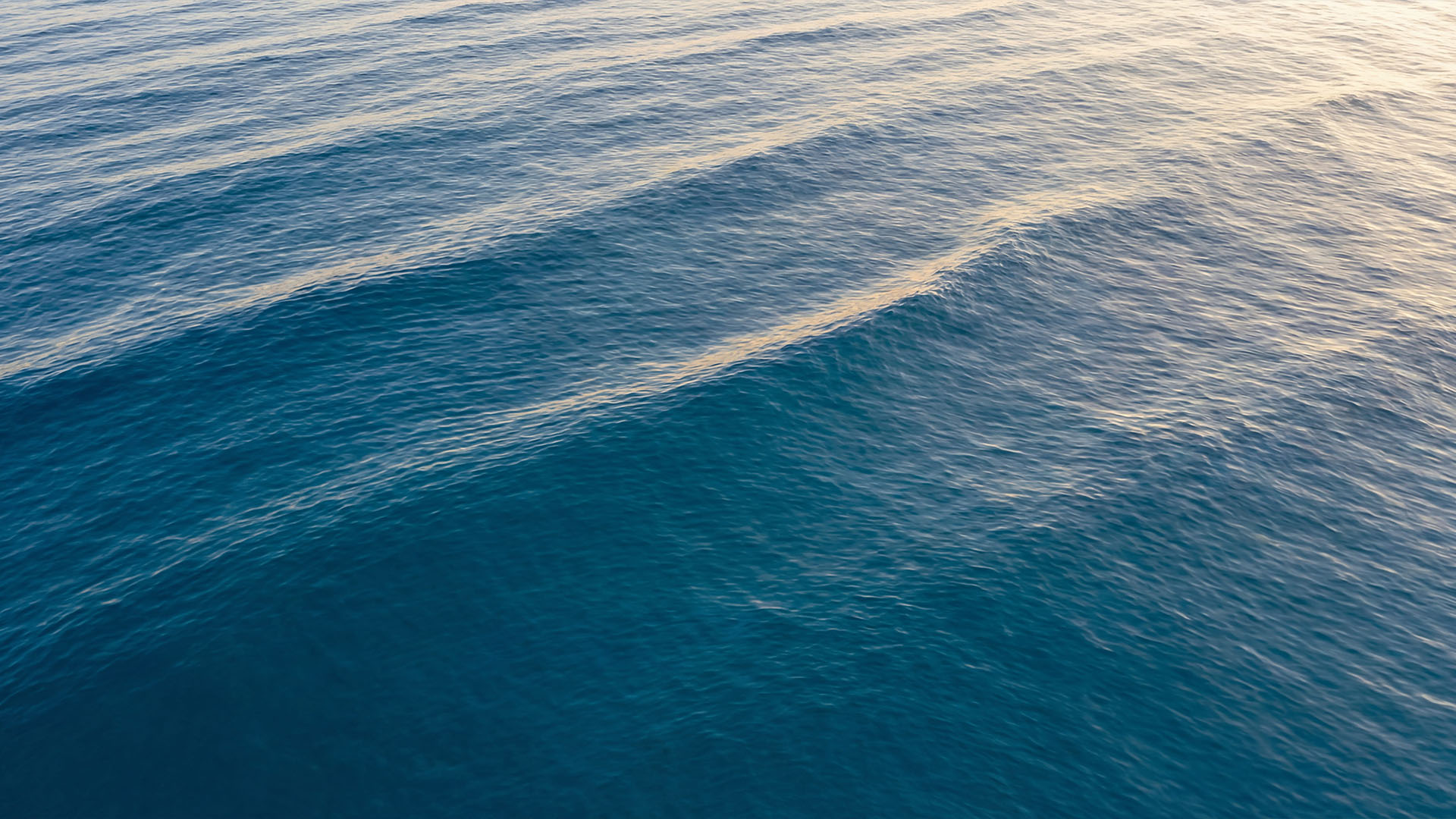Calm ocean surface with soft light and gentle waves along the Marbella coastline