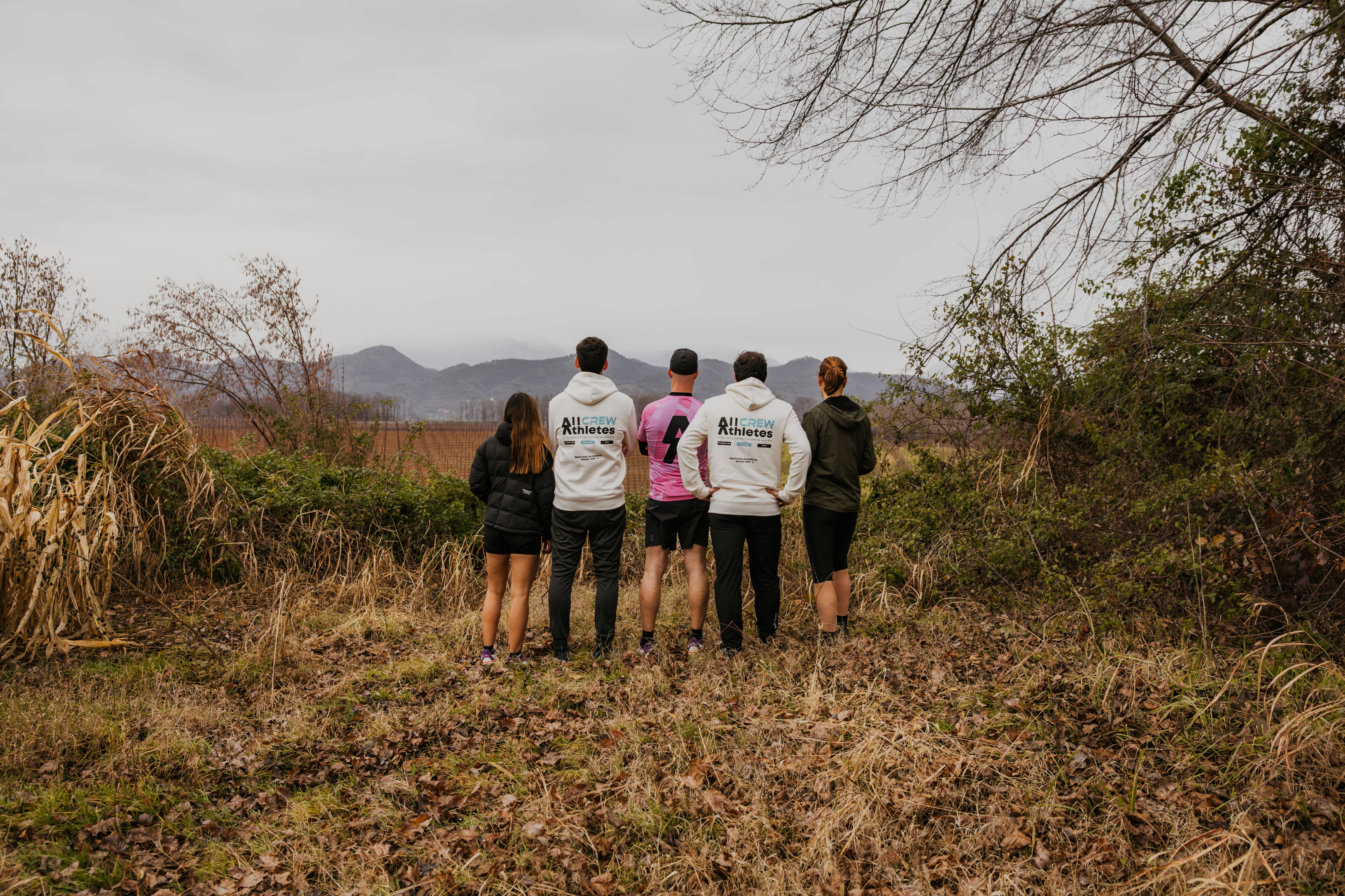 Black and white image of people working at a table with laptops, showing hands gesturing during discussion of digital content displayed on screens, with fabrica® logo in the corner.