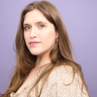 a man with a goatee smiles at the camera