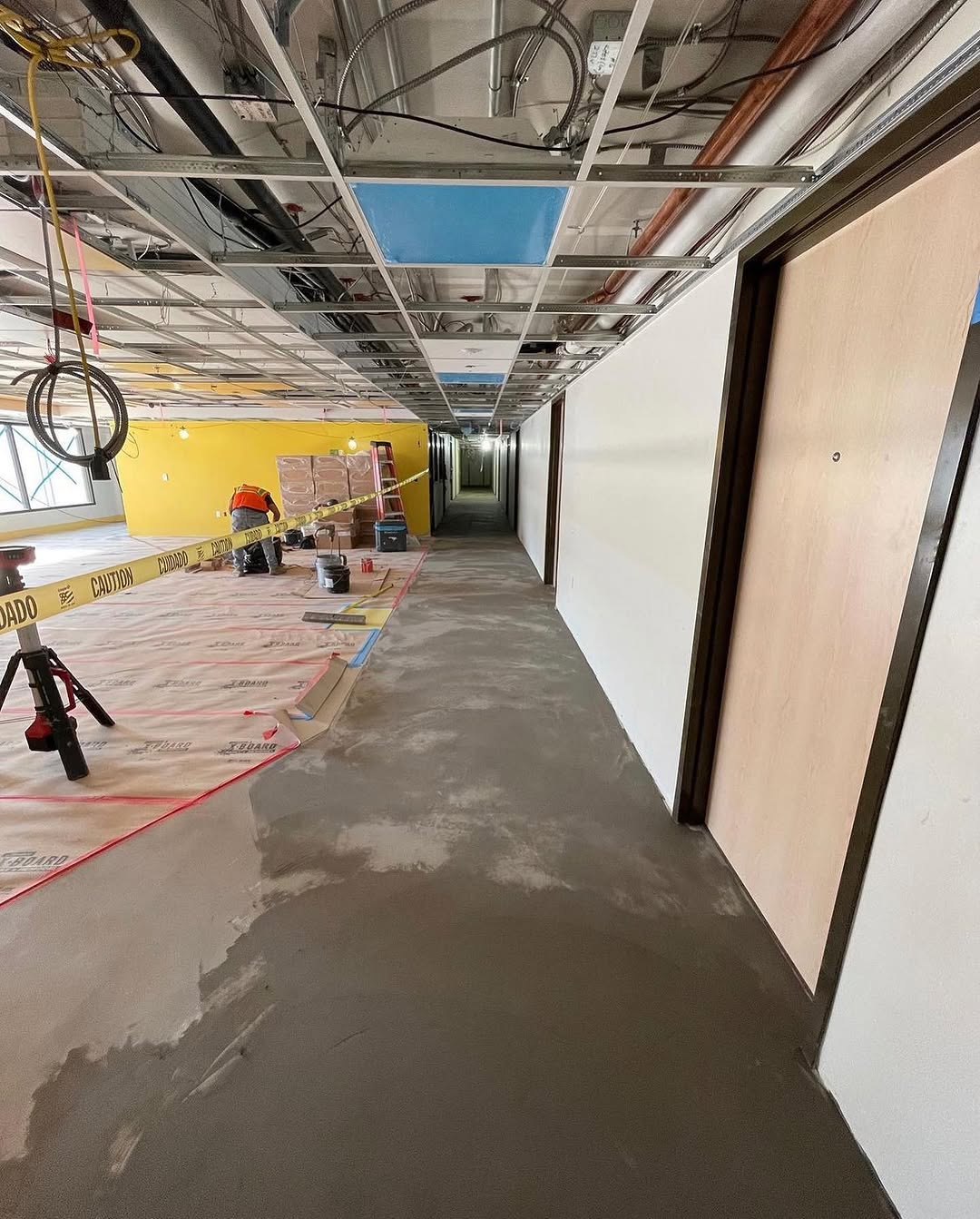 Corridor slab prepped and protected ahead of the underlayment pour
