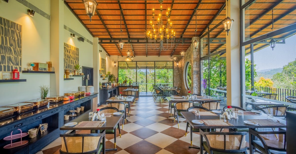 Spacious restaurant with stylish decor and large windows showcasing a scenic view.