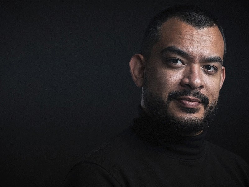 a blurry photo of a person standing in front of a wall