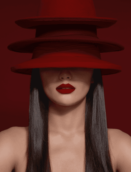 A woman with long black hair is wearing a stylish red hat, exuding confidence and elegance.