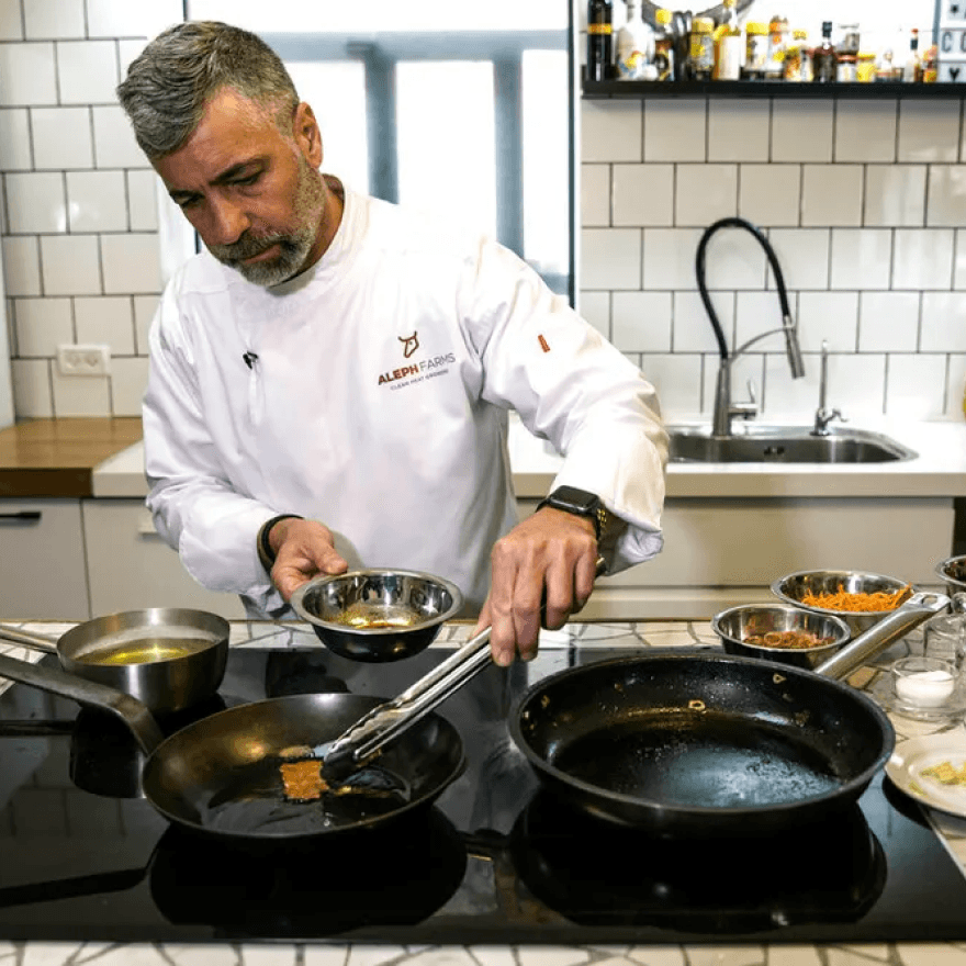 A chef works diligently in a kitchen.