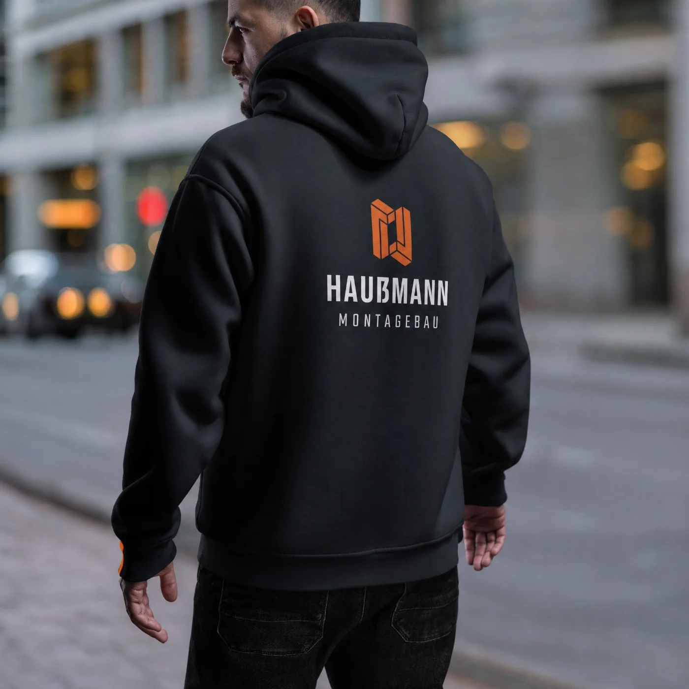 Person walking on a city street with buildings in the background.