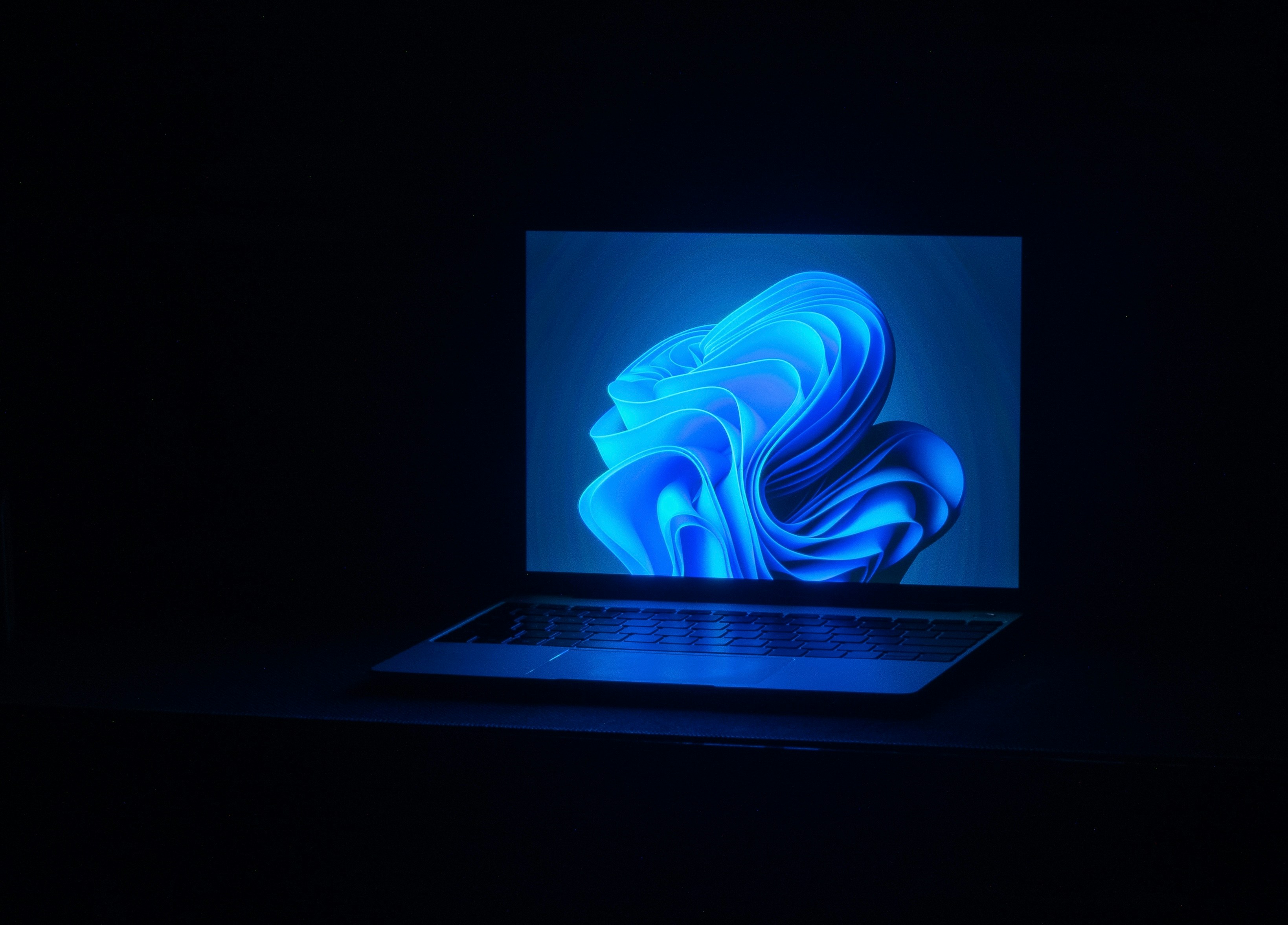a macbook air laptop in a dark room