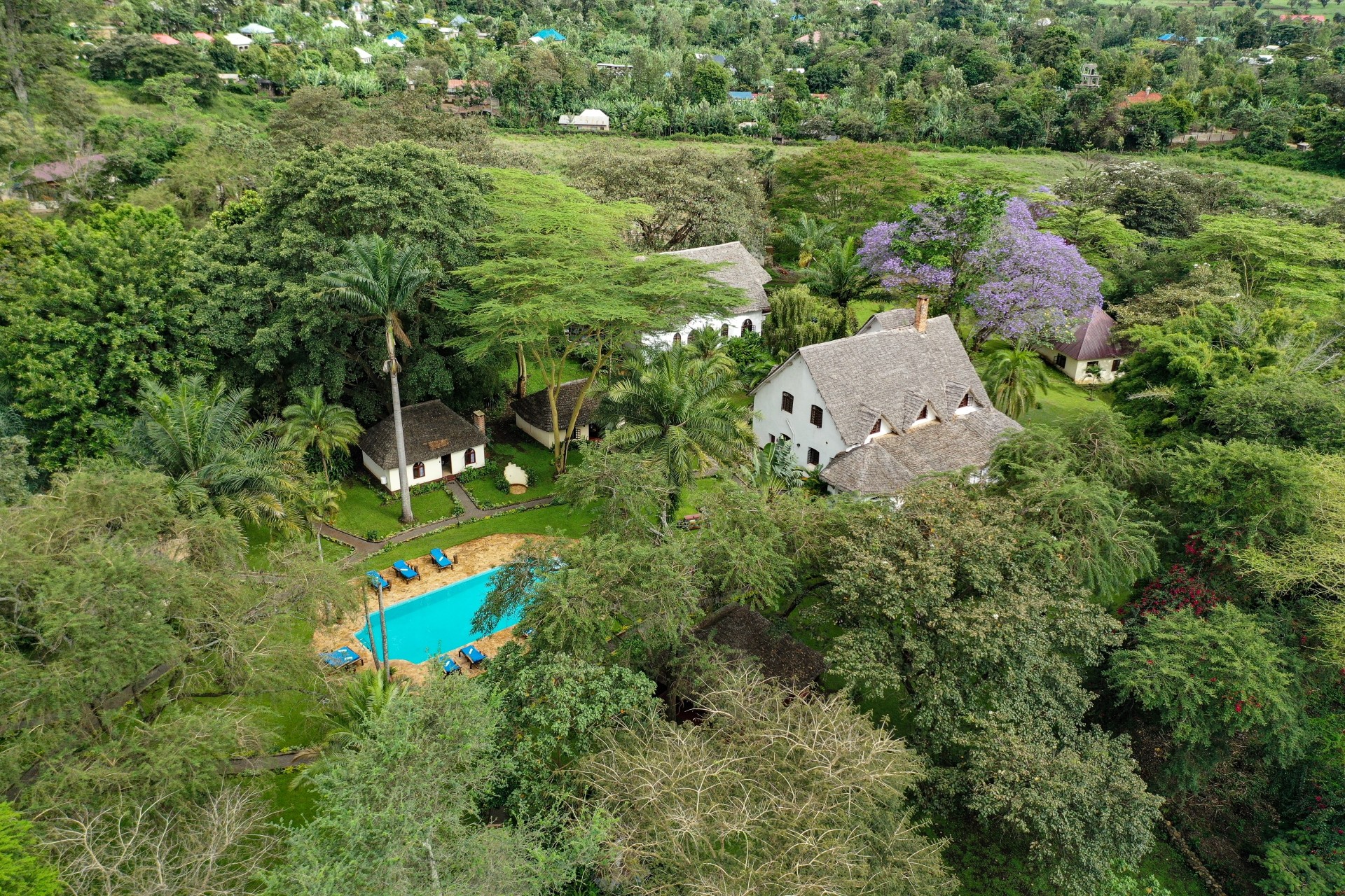 Cottage exterior at Arusha Safari Lodge with Mount Meru in the distance
