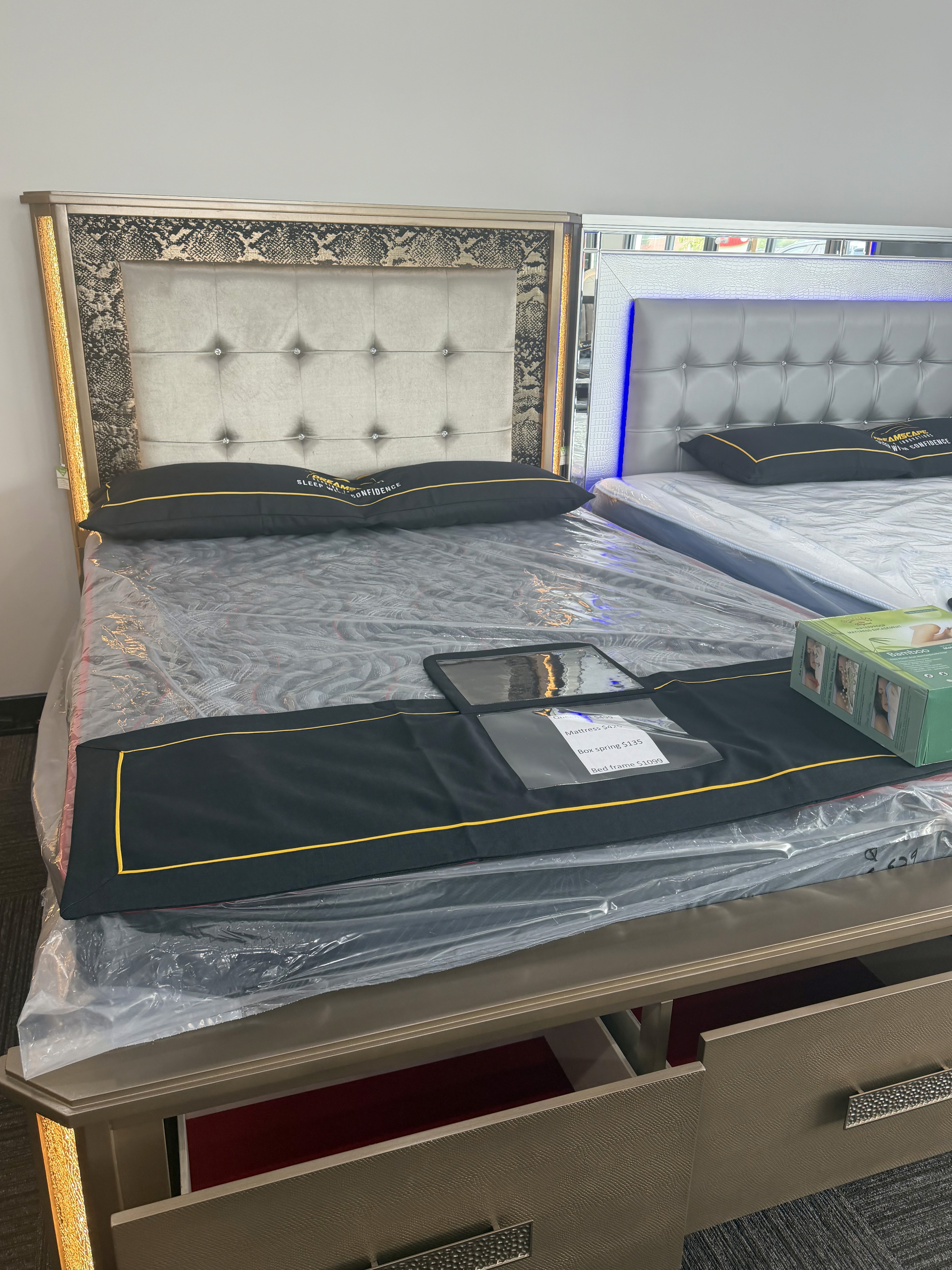 Silver panel bed and mattress in the showroom