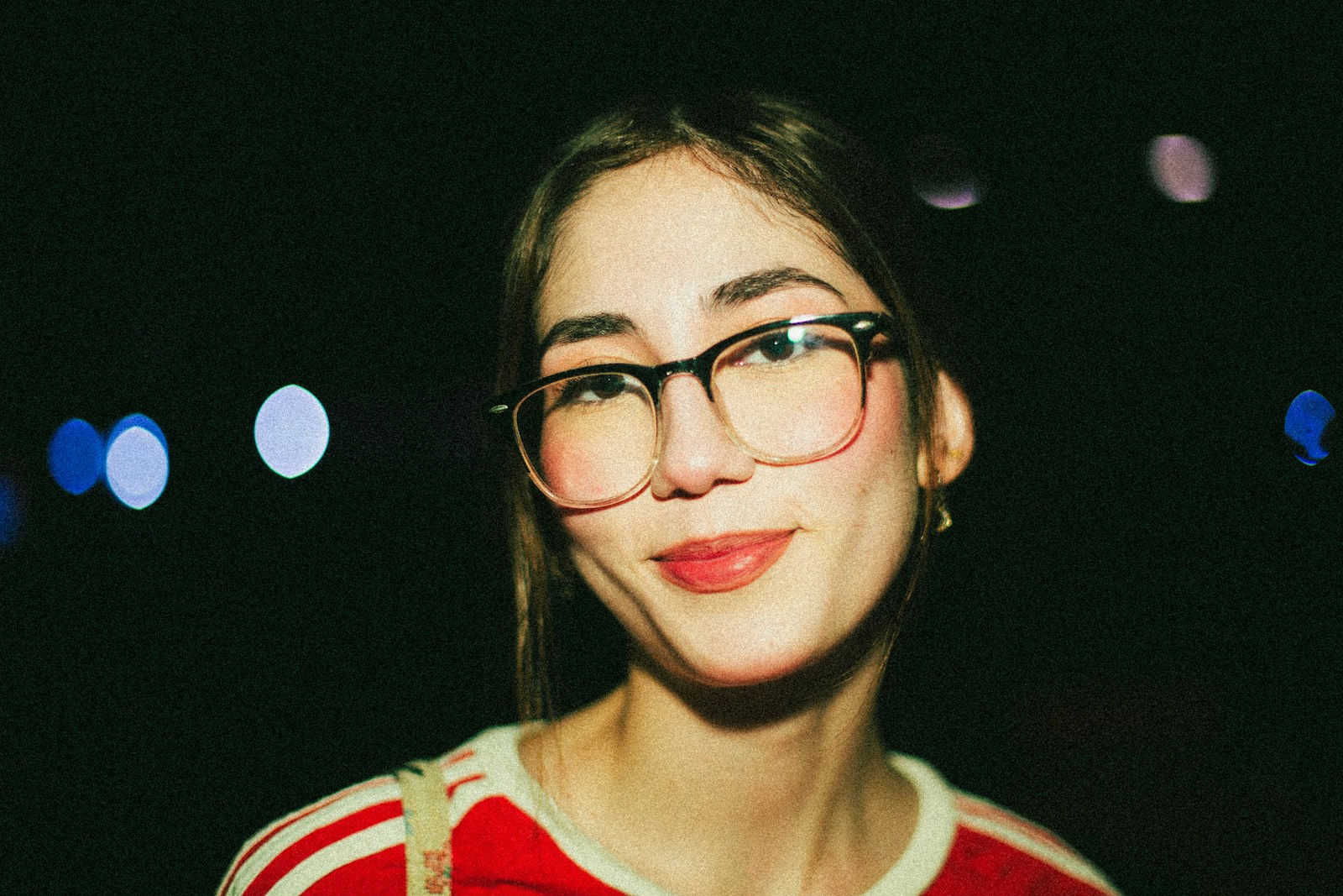 Smiling woman wearing two-tone panto glasses and a red striped top