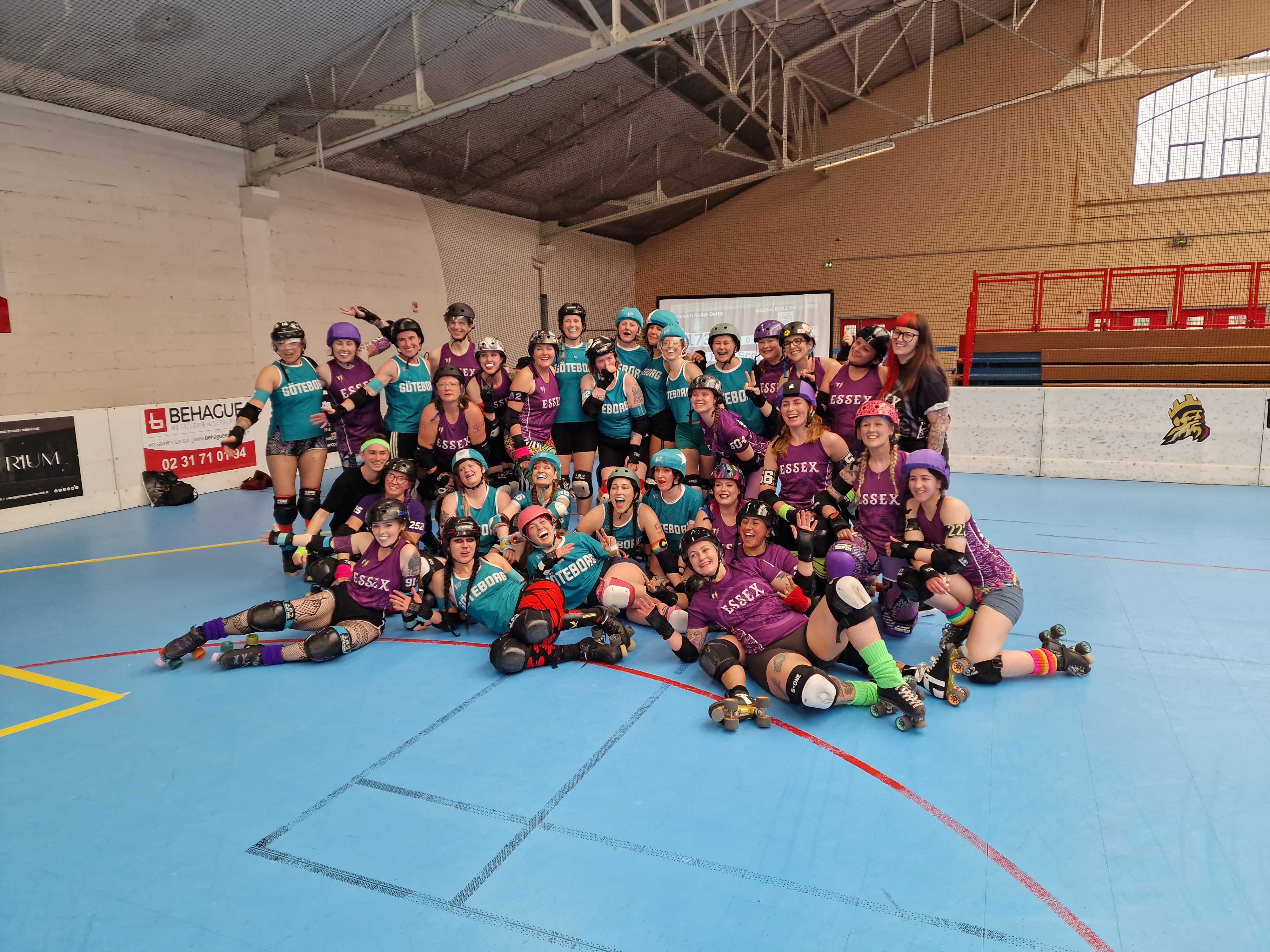 A roller derby team posing in a line for a photo.