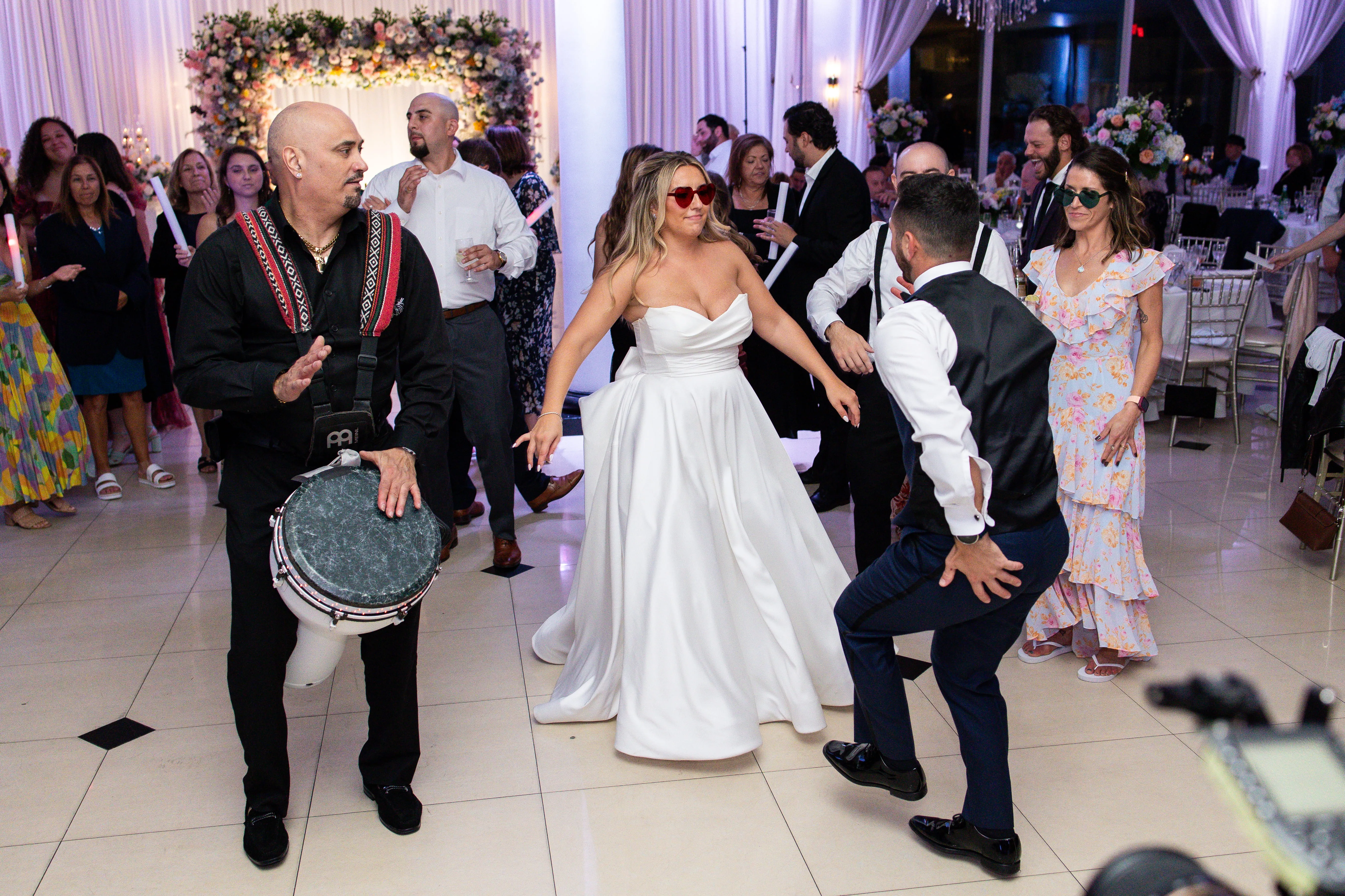Wedding DJ performing with live percussionist creating hybrid entertainment experience