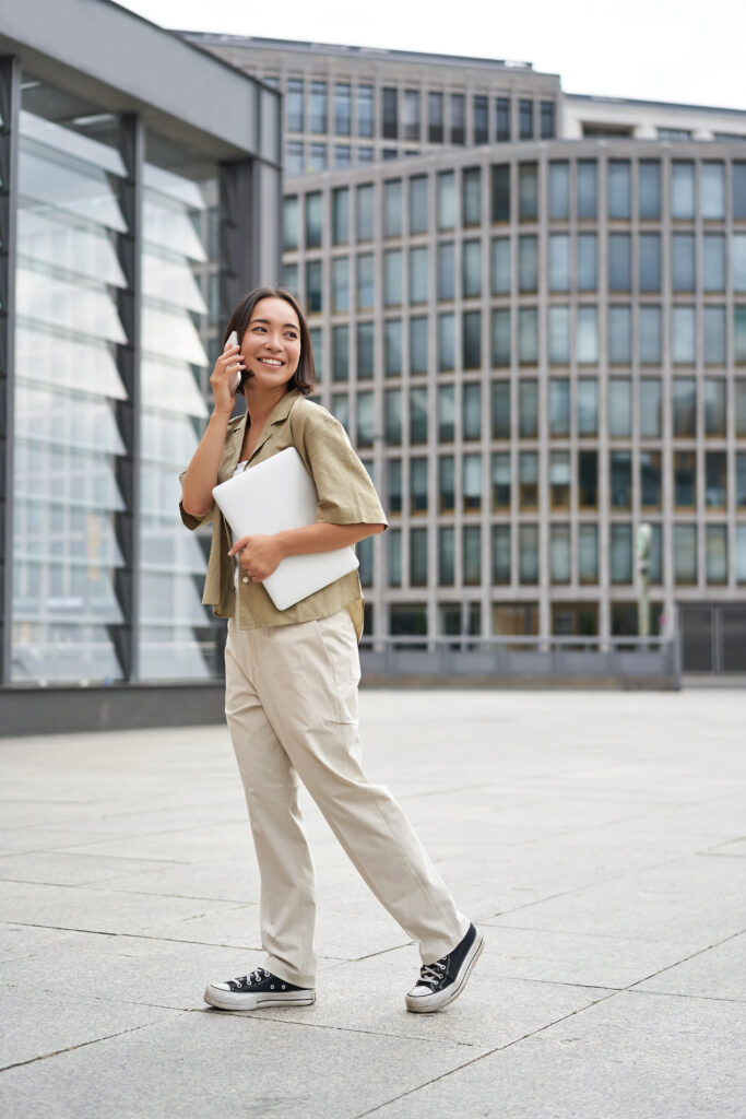 Woman holding an EMF protection card in a casual setting
