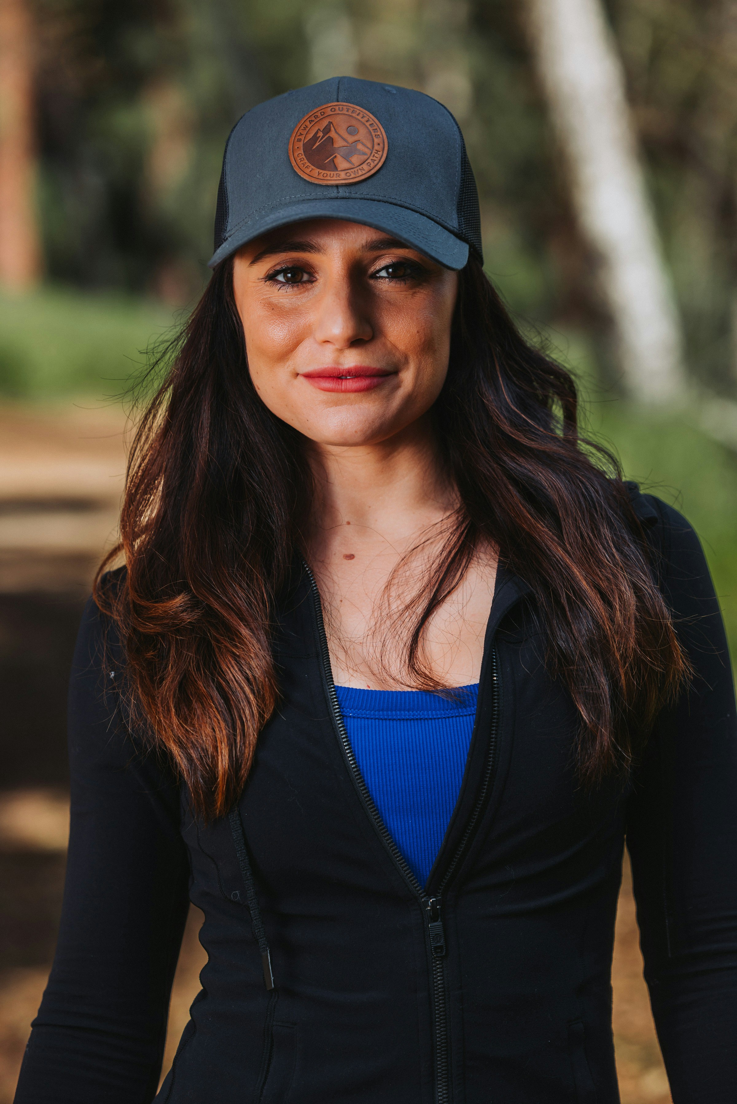 A woman wearing a black jacket and a blue top
