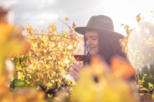 Lady tasting a wine in the vineyard in Margaret River