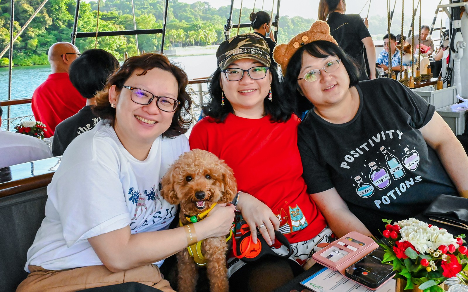 Dog-friendly breakfast cruise on The Royal Albatross, Singapore, with passengers enjoying the view.