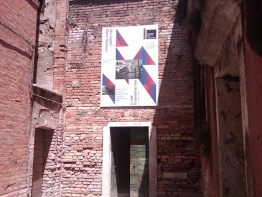 Poster hung up on a old brick building