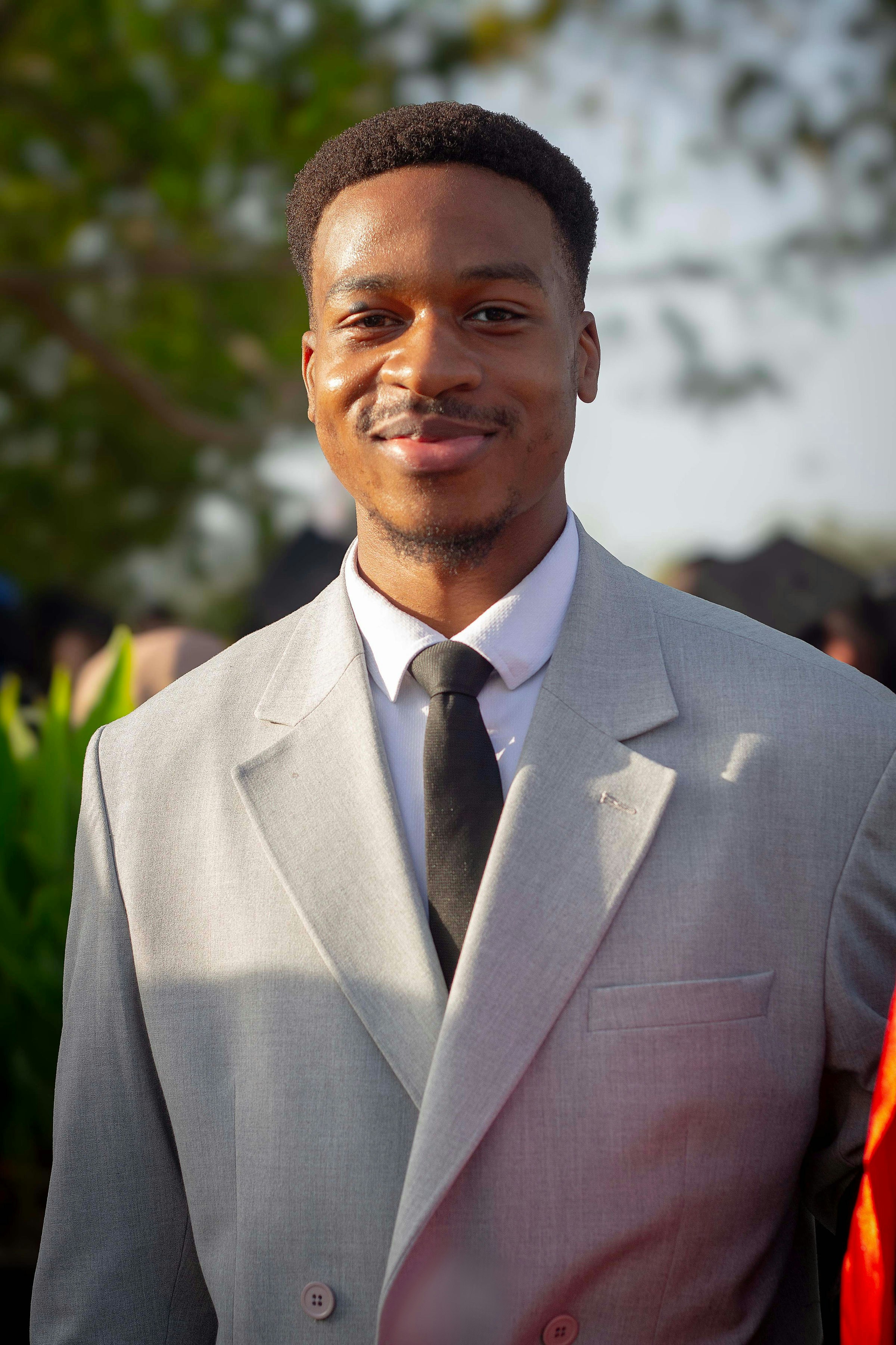 A man in a suit and tie posing for a picture
