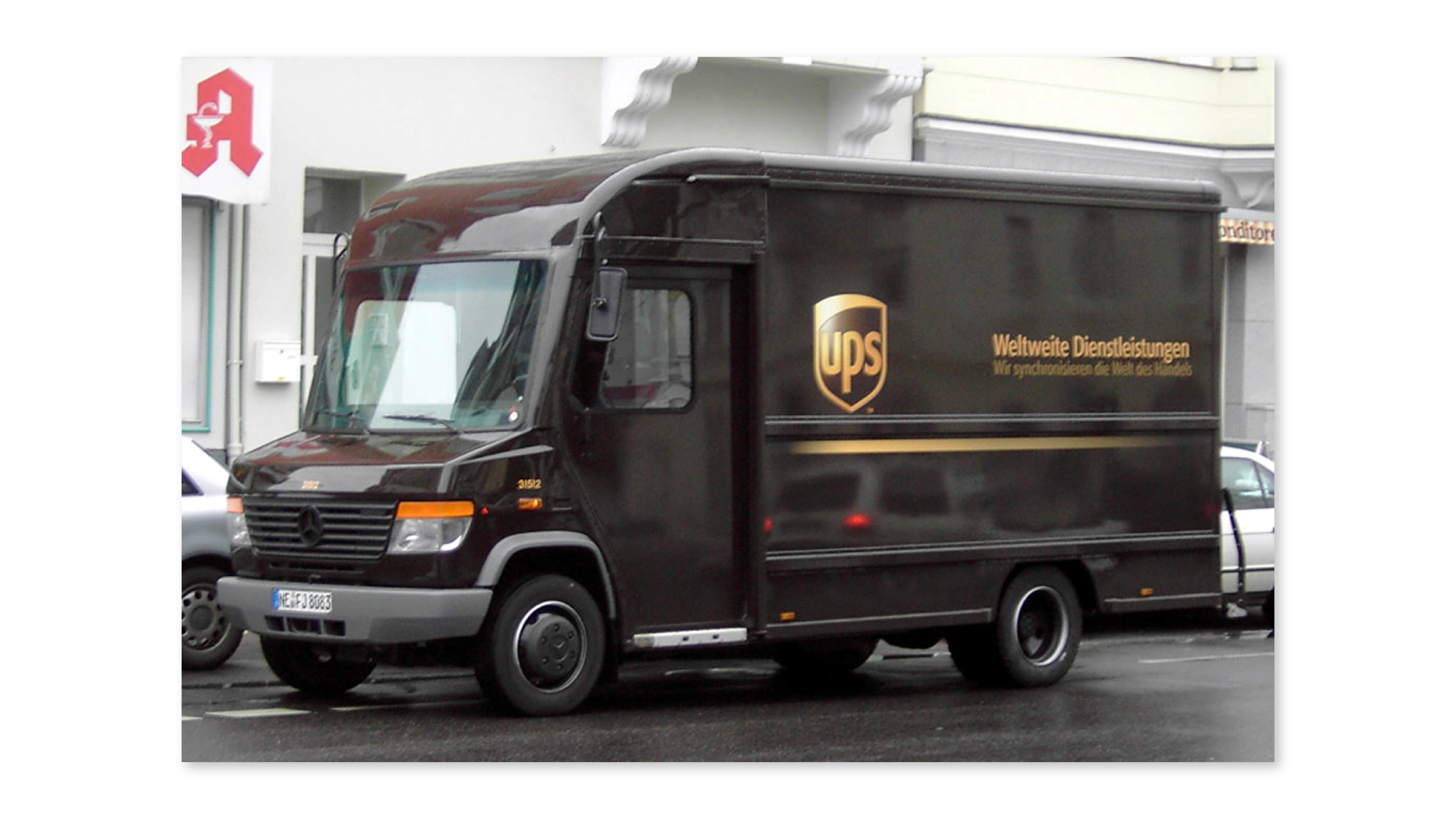 Brown UPS delivery truck parked on a city street, showing the brand’s dark brown and gold color scheme.