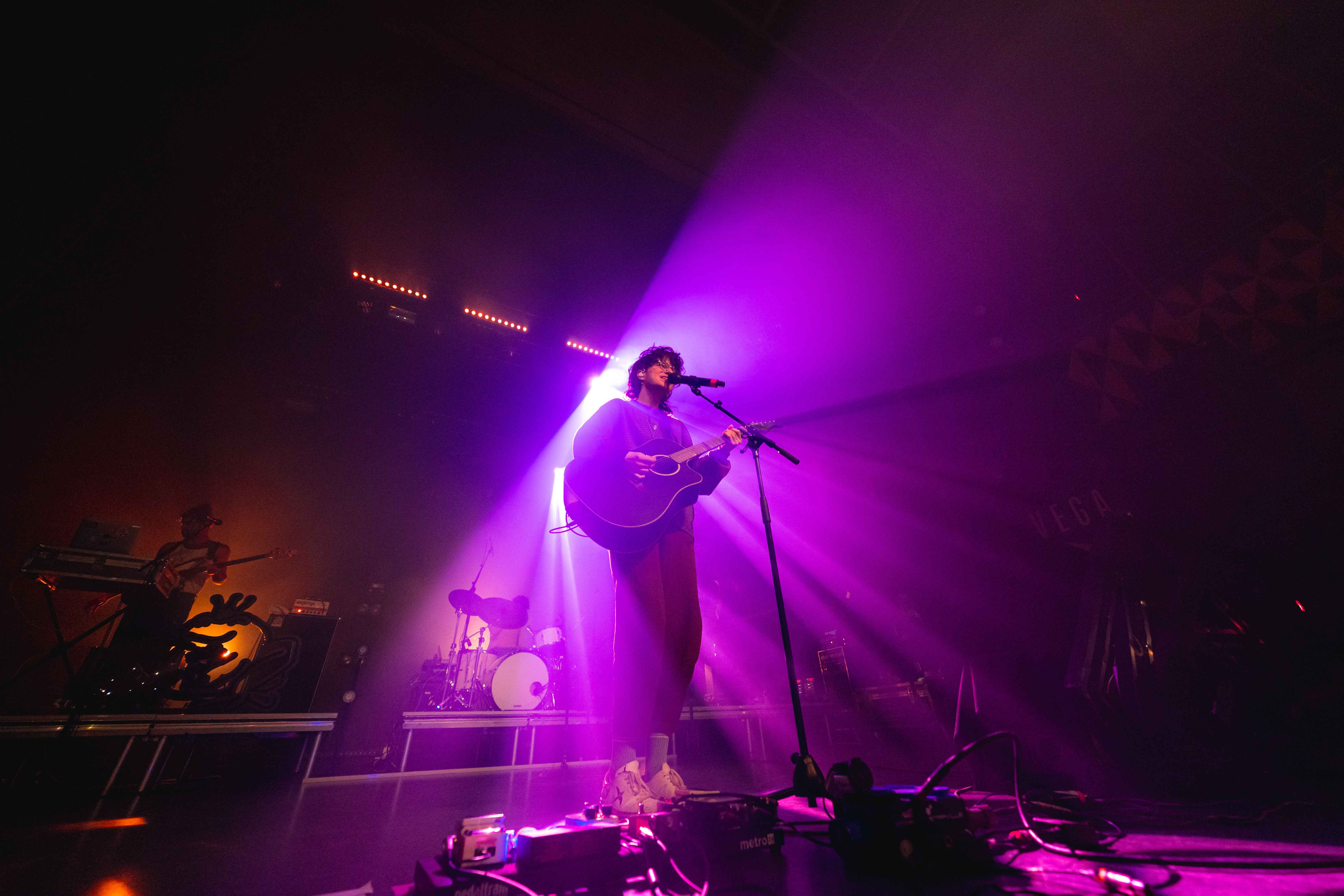 cavetown musician on stage with purple light.