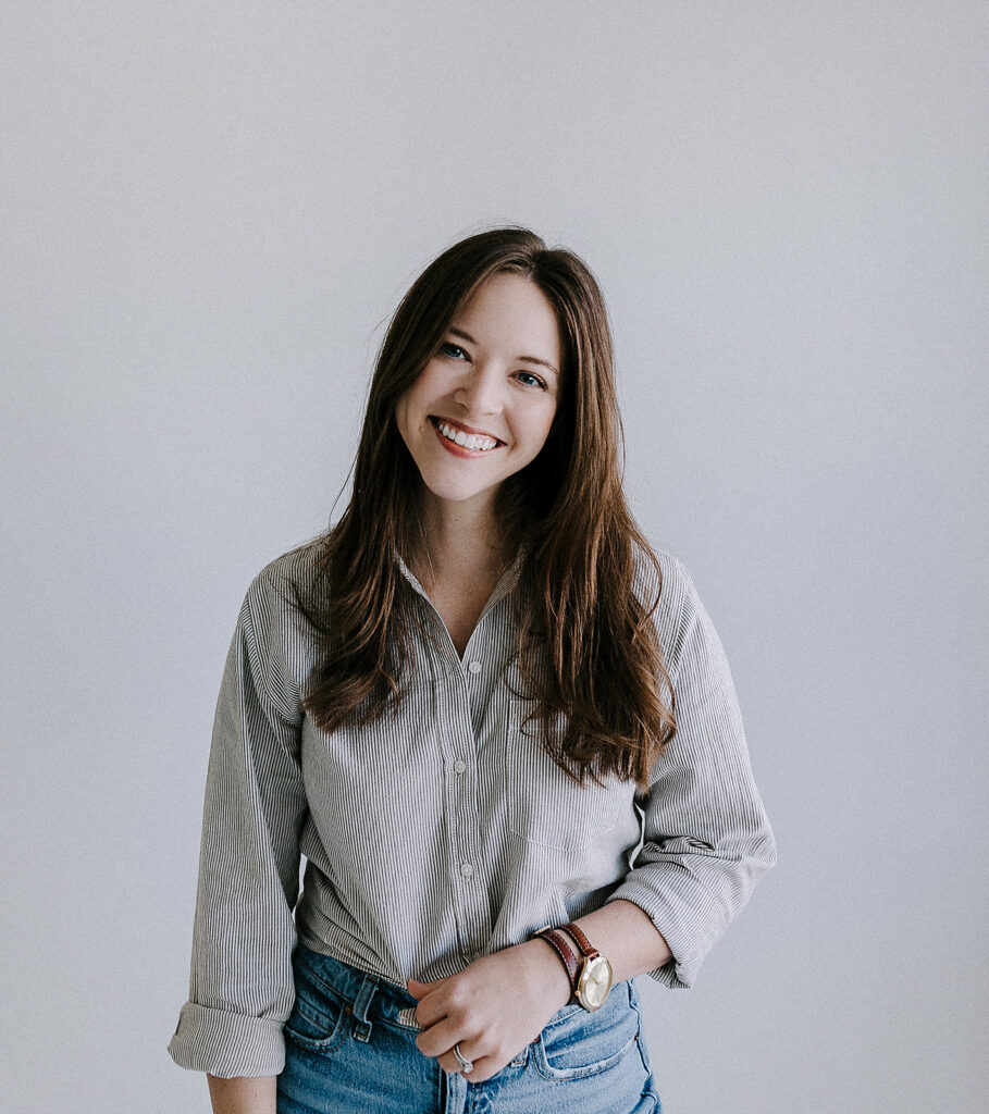 Christi Martin poses in a natural light studio setting at Revelator Studio in Shreveport, highlighting the bright and airy space perfect for photographers, videographers, and influencers.