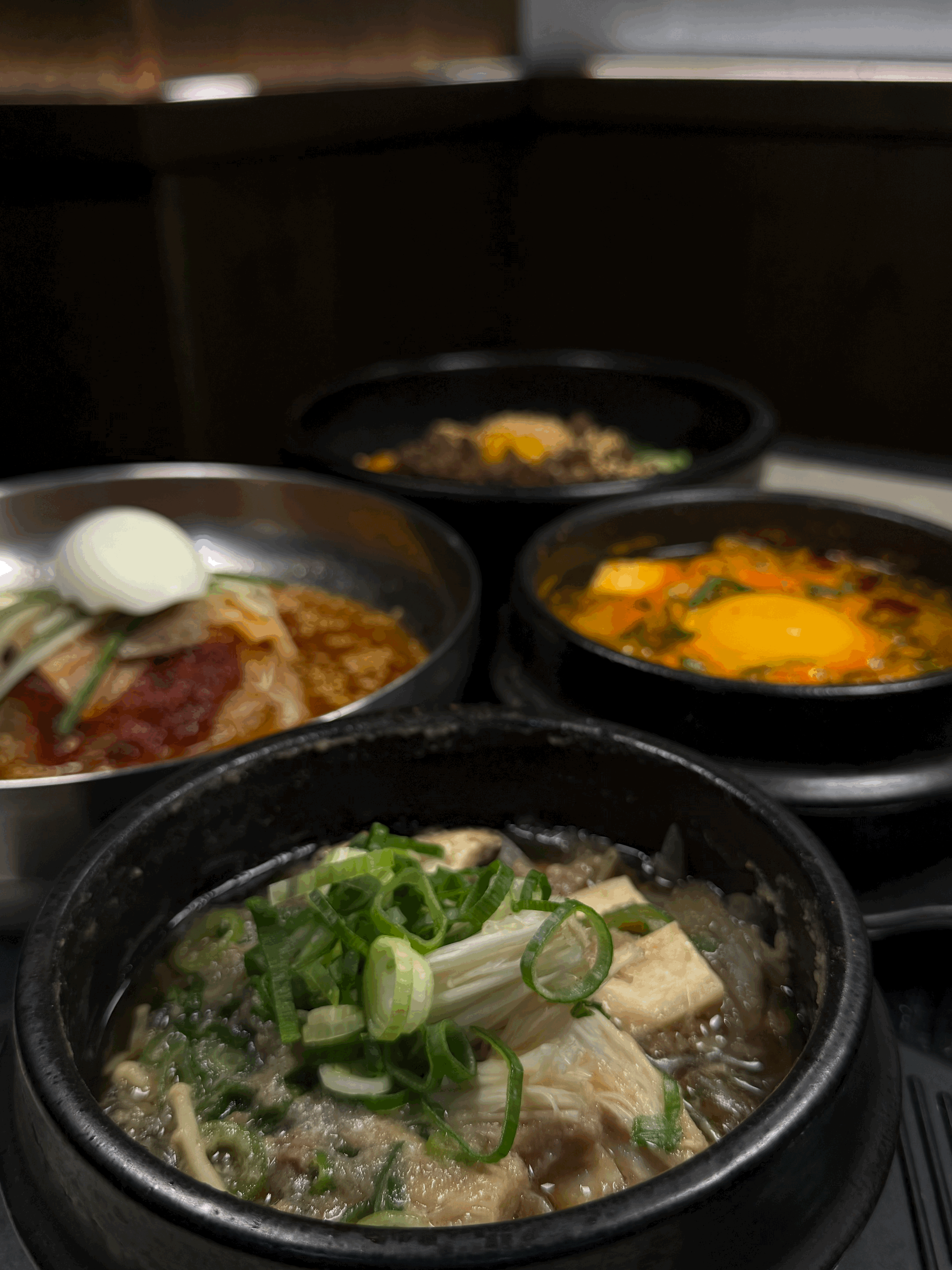 Close-up of a delicious-looking wrap, filled with richly seasoned meat and fresh vegetables, served on a white plate with extra onion and parsley garnishes.