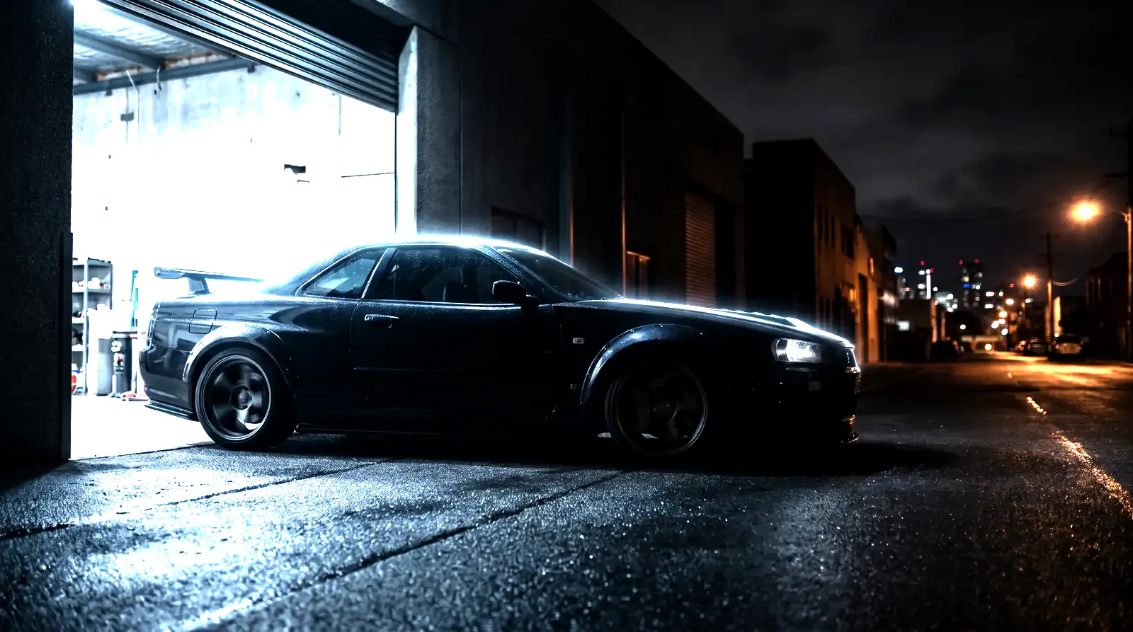A wide-body performance car rolling out of the AL Custom workshop bay at night in Doral, Miami
