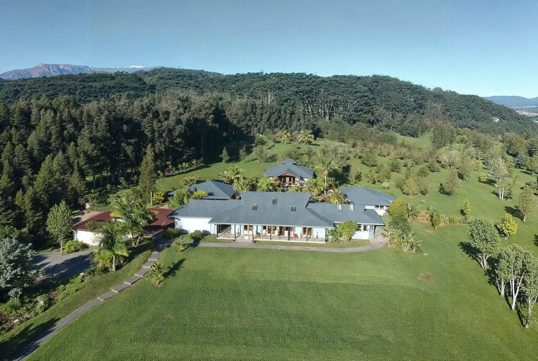 Aerial view of Kahuna Falls retreat estate with main lodge and lush Hawaiian landscape