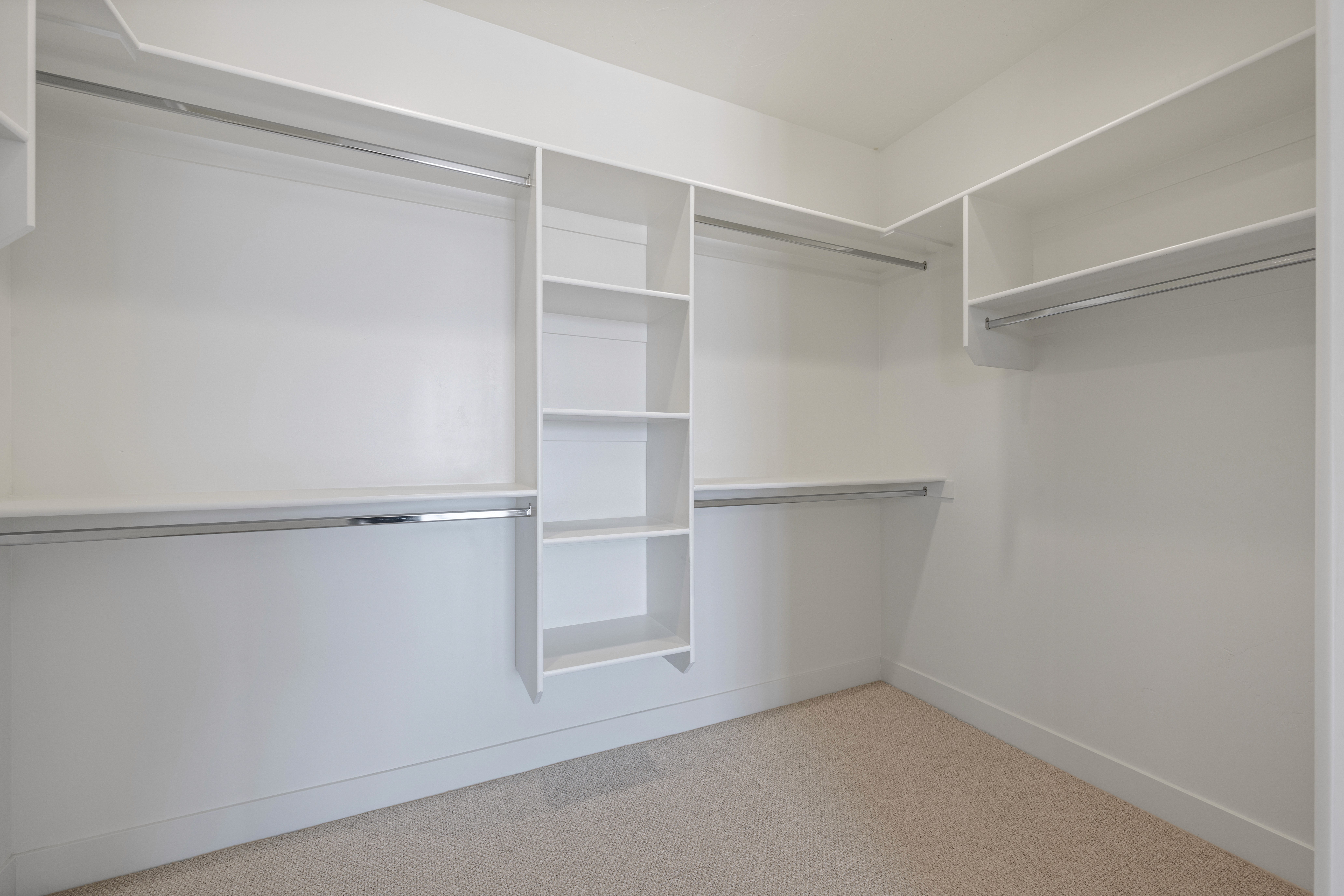 Primary suite custom closet in The Nest at Falcon Ridge with built-in shelving and storage solutions.