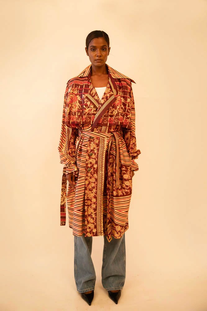 Rust-colored silk trench coat crafted from vintage fabric, featuring a relaxed fit, self-tie belt, and no inner lining, celebrating lightweight layering and conscious design.