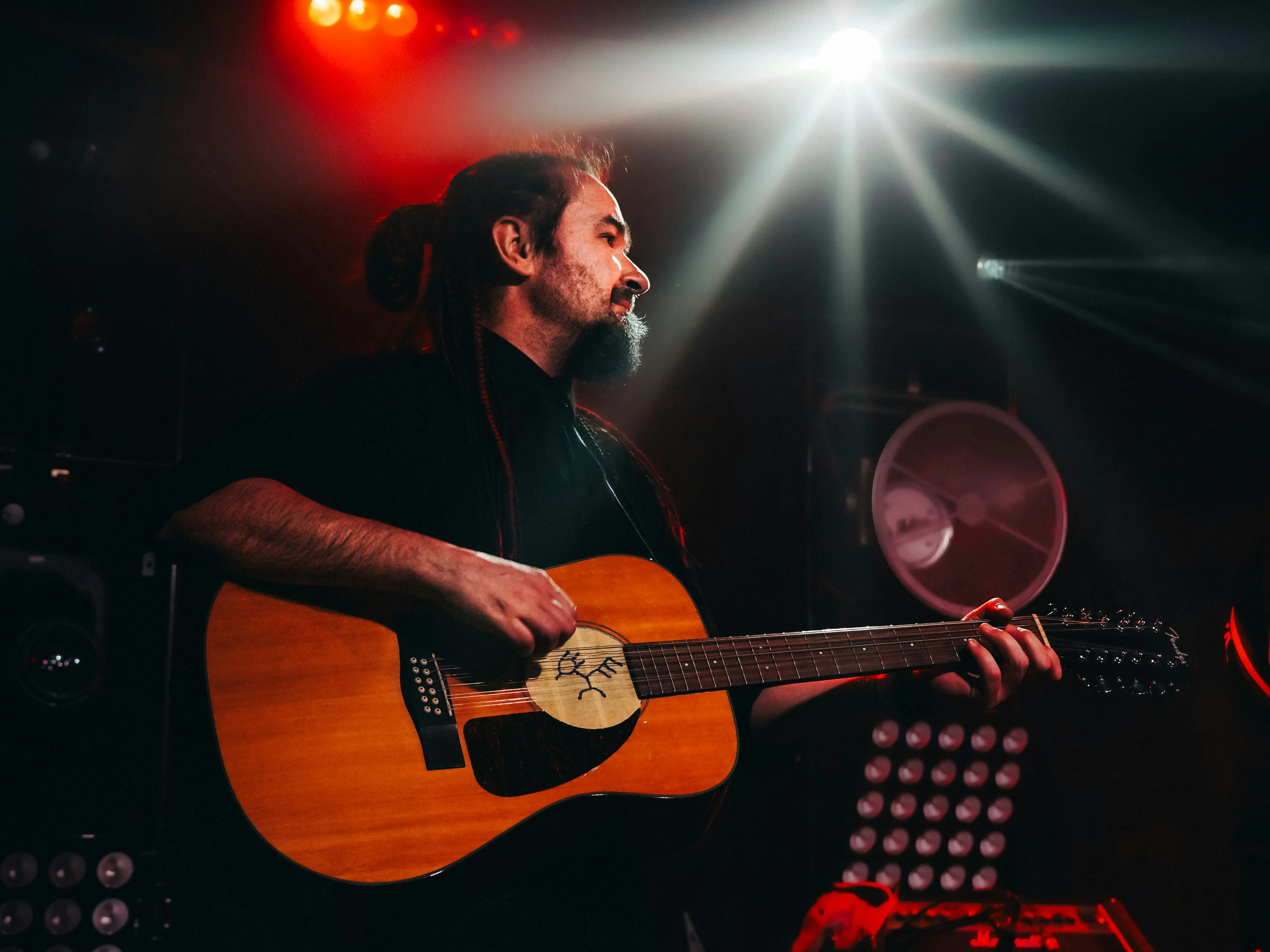 A man playing a guitar on a stage