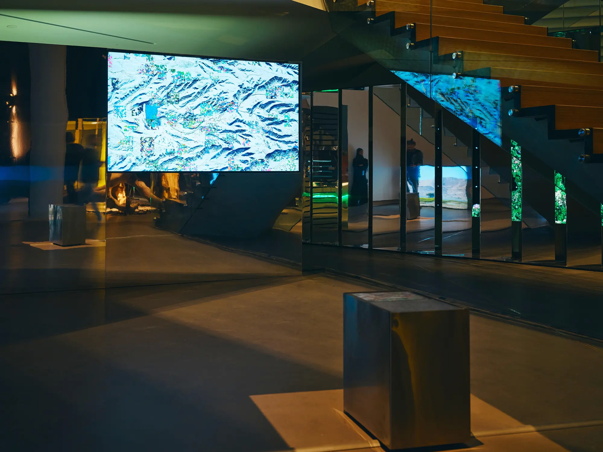Digital art display in modern interior with glass staircase