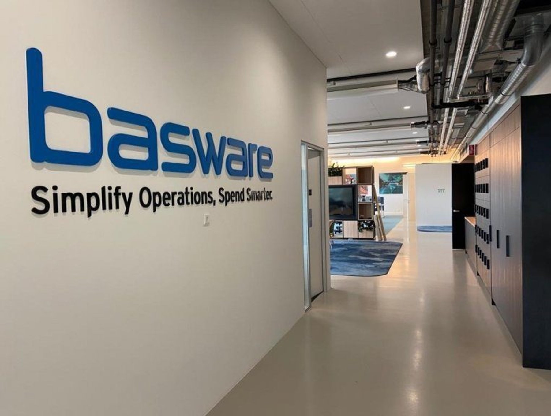 Basware office wall with the slogan Simplify Operations, Spend Smarter