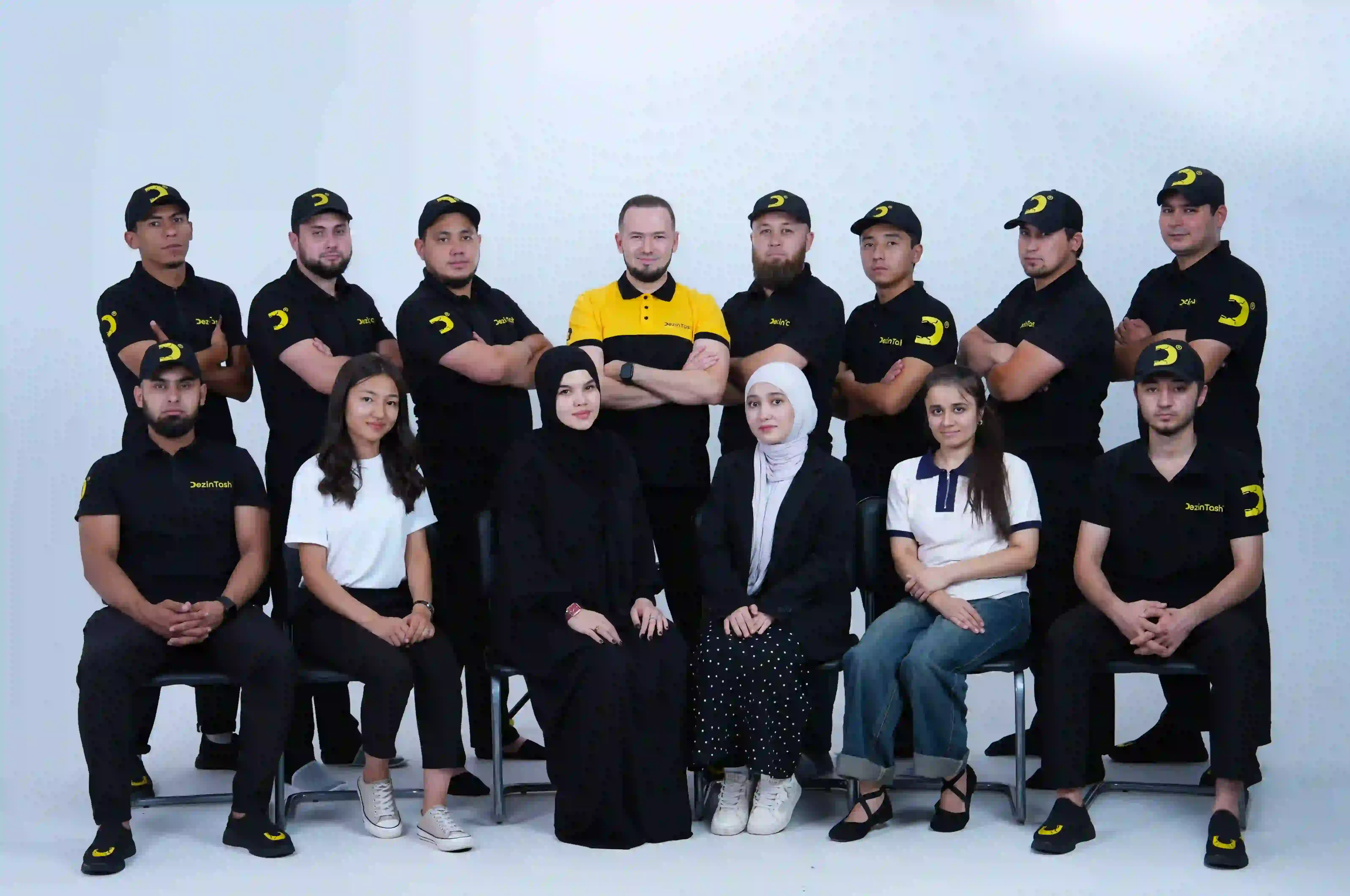 Two men discuss a project while standing at a laptop in an office.