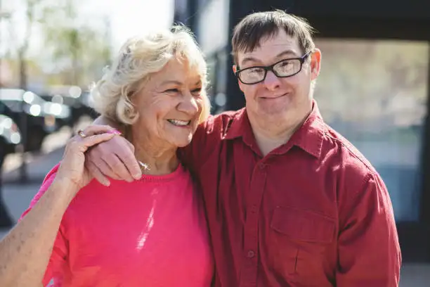 Disabled man hugging mother