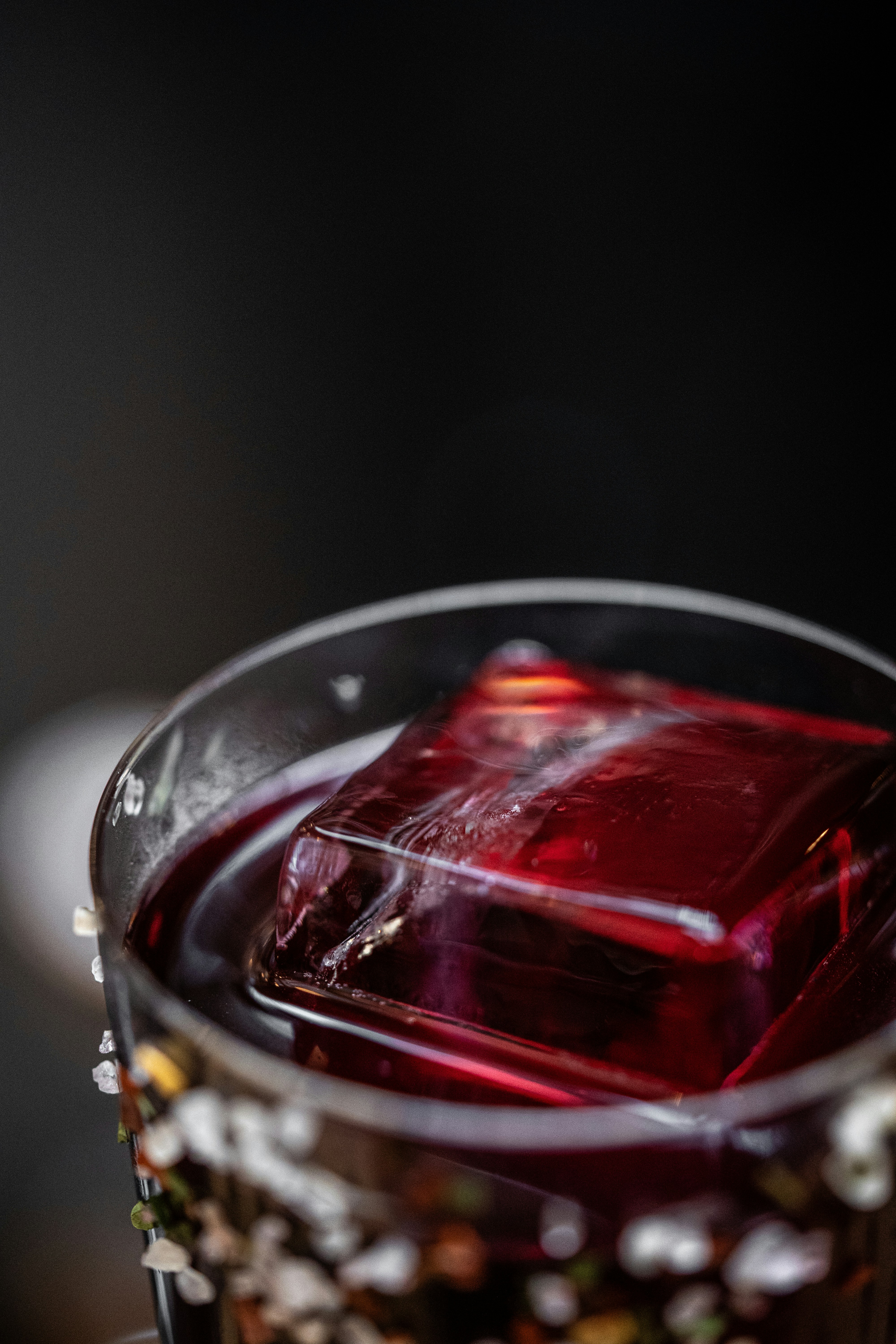 a glass filled with liquid sitting on top of a table