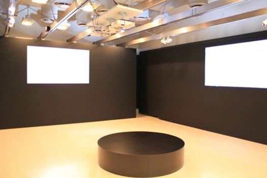a room with a an image projected on the left wall and another one projected on the right wall